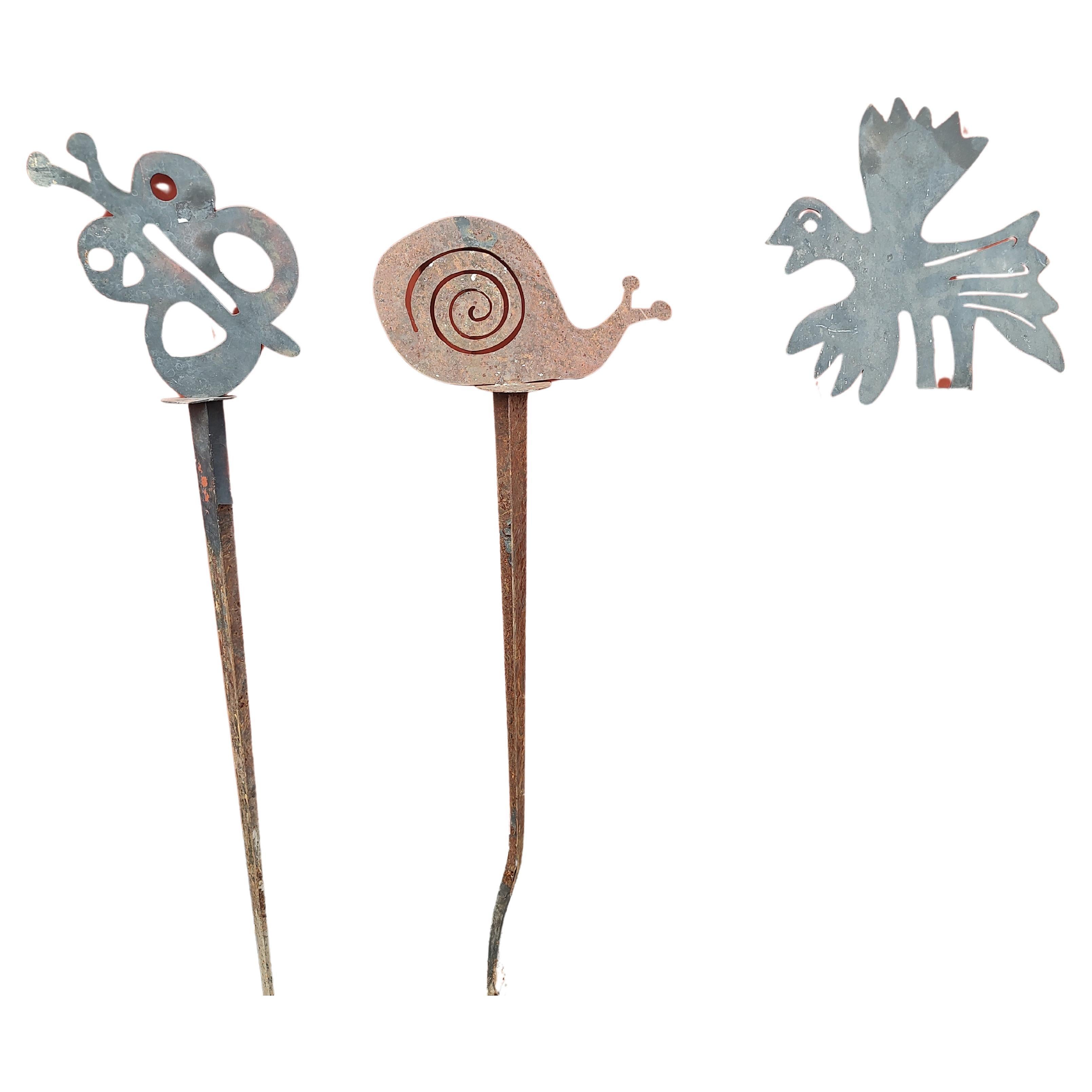 Spectacular set of 3 garden sculptures in Iron by Artist Ernest Shaw.  A bird a snail and a butterfly make up the trio. Tallest is 57 inches high x 16 x 4. Spikes are mostly straight but do have some wear, probably from hitting rocks underground.