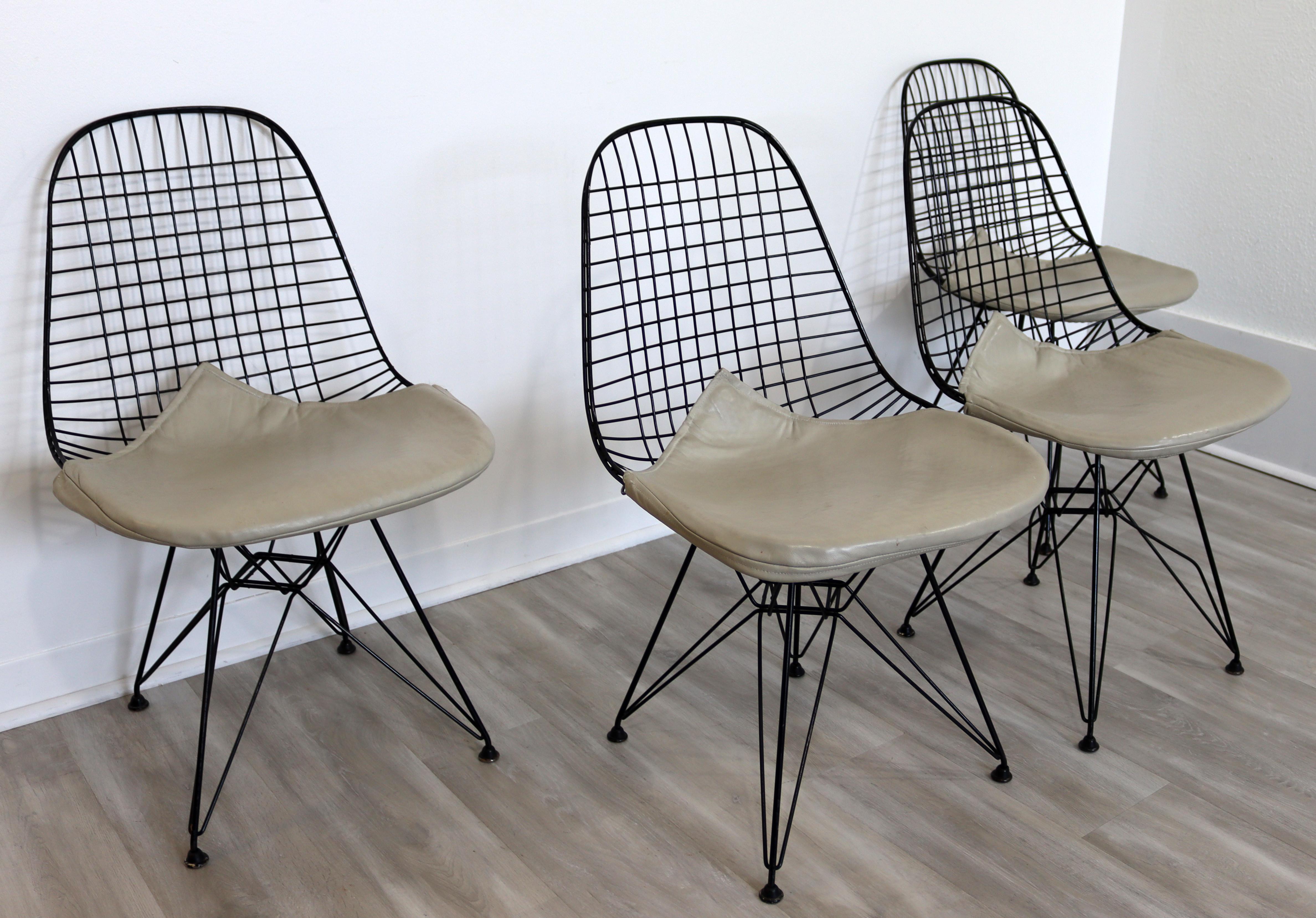 For your consideration is a brilliant set of four, Eiffel Tower base side chairs, with beige Bikini covers, by Charles & Ray Eames, circa the 1960s. In very good vintage condition. The dimensions are 19