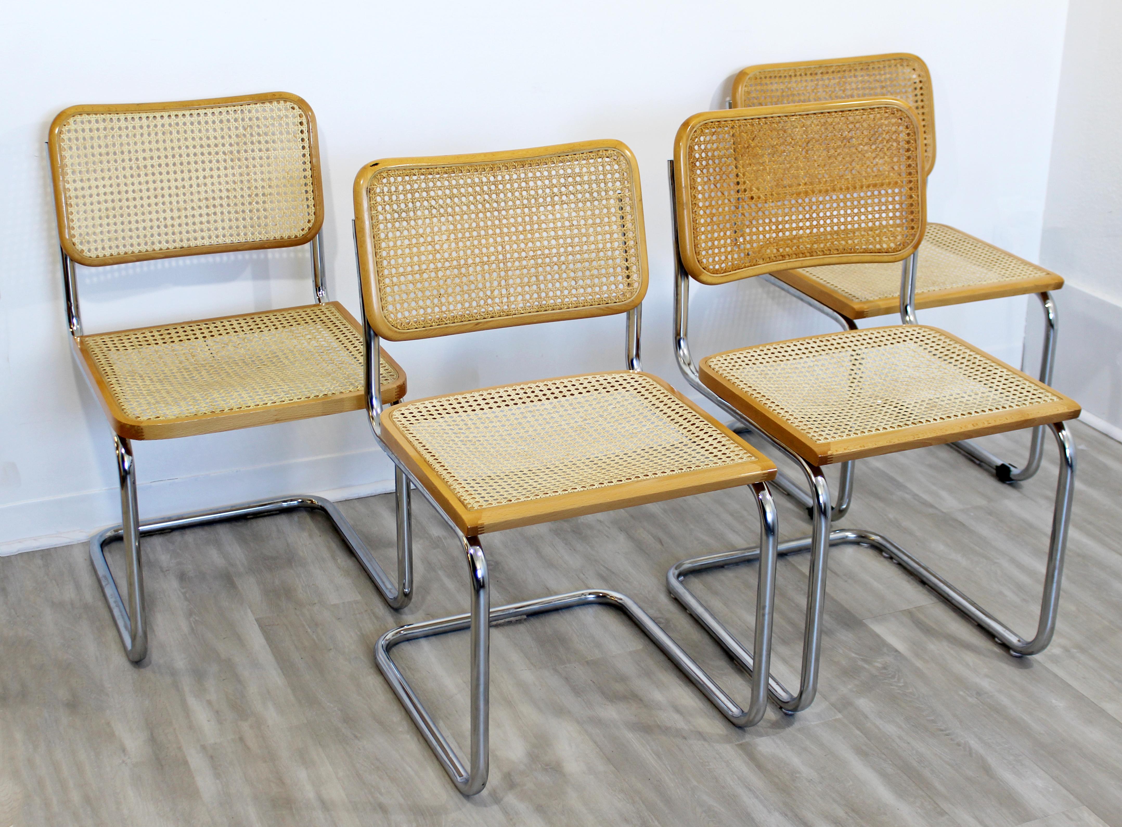 For your consideration is a great set of four, wood and cane side chairs, on cantilever chrome bases, by Marcel Breuer, made in Italy, circa 1970s. Three of the chairs have squared seats and one has a rounded seat. In very good vintage condition.