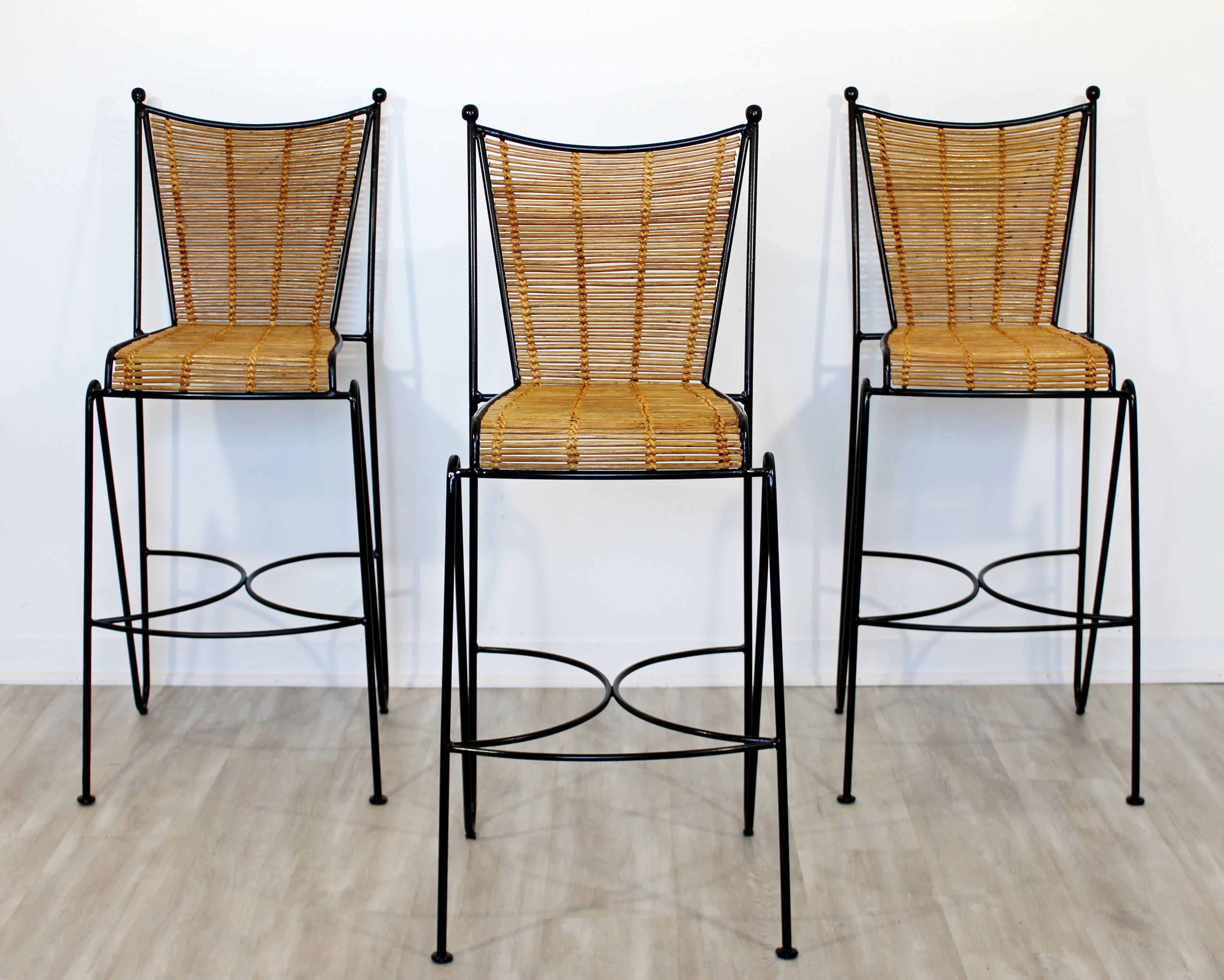 For your consideration is a beautiful set of three bamboo rattan and wrought iron tall bar stools, by Pipsan Saarinen Swanson wrought iron and cane barstools, attributed to Ficks Reed, circa the 1960s. In excellent vintage condition. The stools just