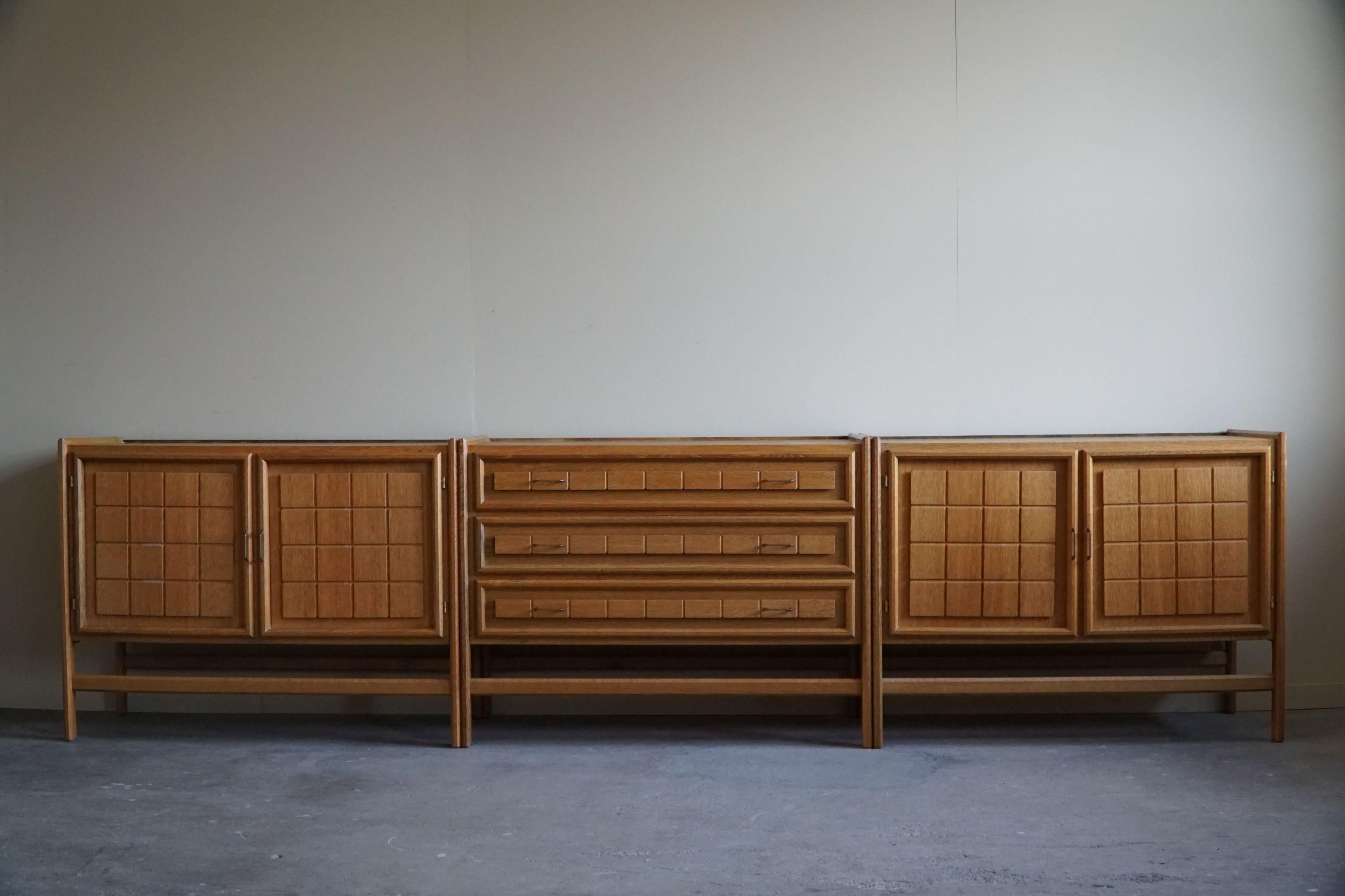 This fascinating set contains two cabinets and one chest of drawers in solid oak. Great patina and a fine carved front design. Made by a Danish cabinetmaker in the 1960s. 
Can be used as one unit or three separate units. 

These intriguing brutalist