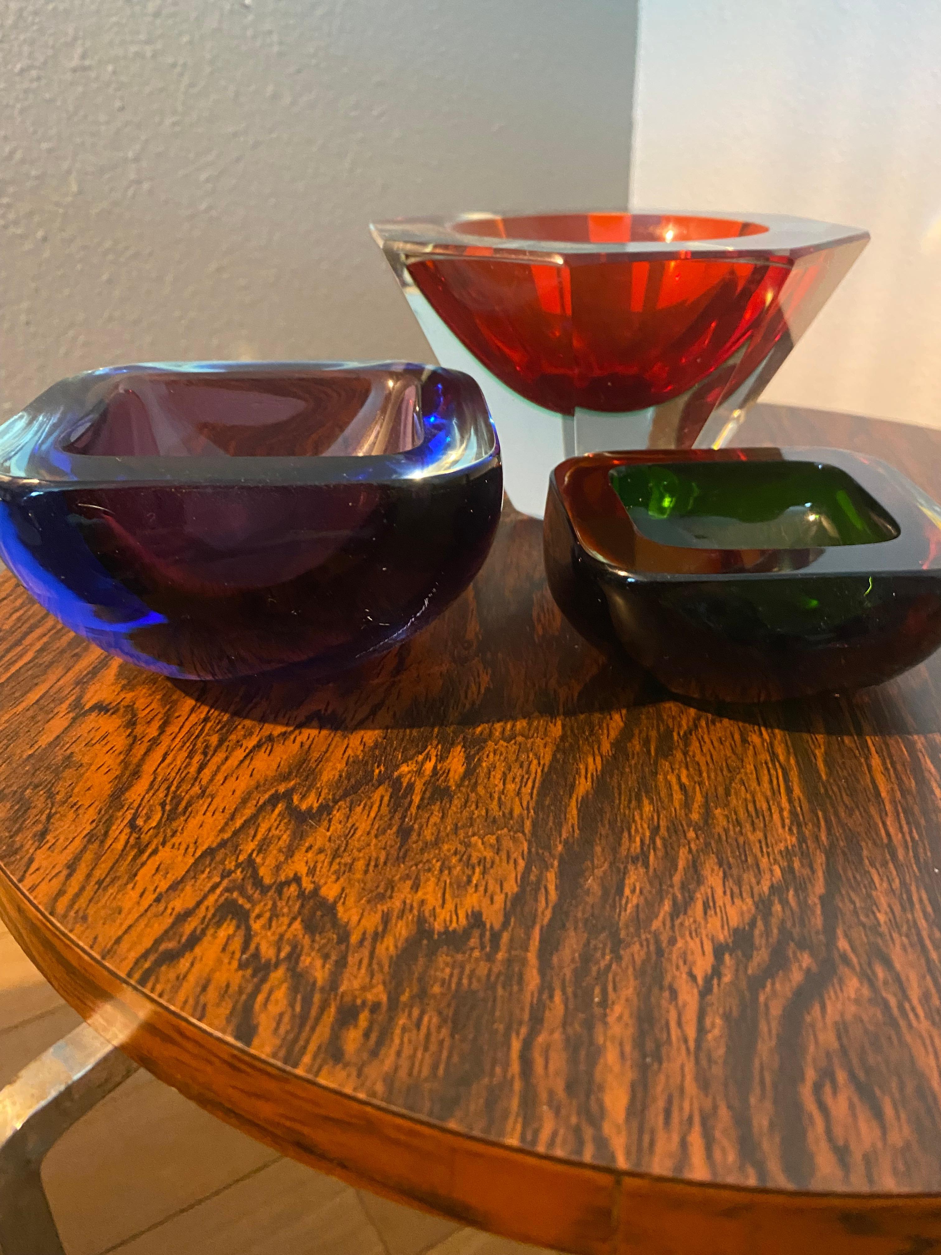 Beautiful midcentury Italian Murano glass bowls. Made using the Sommerso (submerged) glass technique.
Measurements two smaller bowls:
Blue purple bowl: 10x10x5
Brown orange bowl: 8x8x3.5.