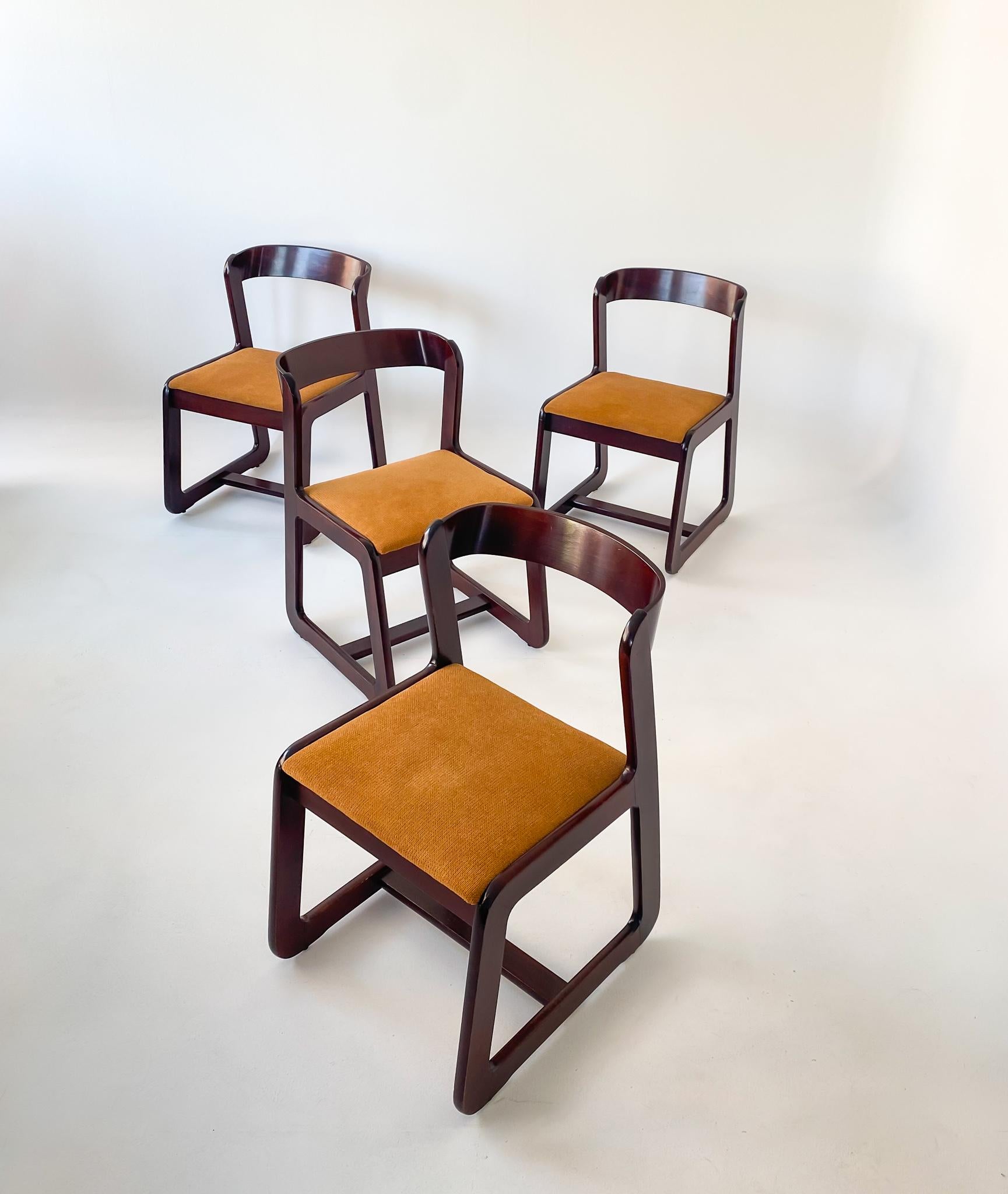 Mid-Century Modern Set of 4 dining chairs by Willy Rizzo for Mario Sabot 1970s.

This dining set of 4 chairs by the Italian Designer Willy Rizzo consists of a wooden frame in light reddish mahogany tone. The seats were re-covered with a matching