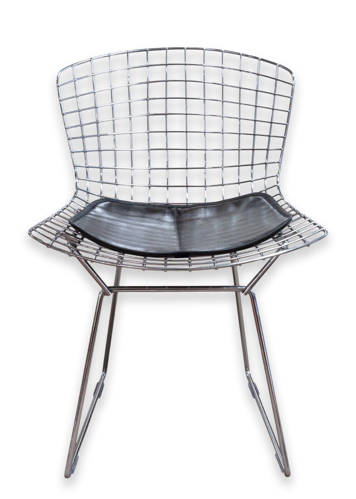 A set of 4 Harry Bertoia for Knoll side chairs. An iconic chair featuring chrome rods and a black leather seat pad. This set of chairs is in very good condition. They measure 29.25 in tall, 21.25 in wide, and 24 in deep. They have a seat height of