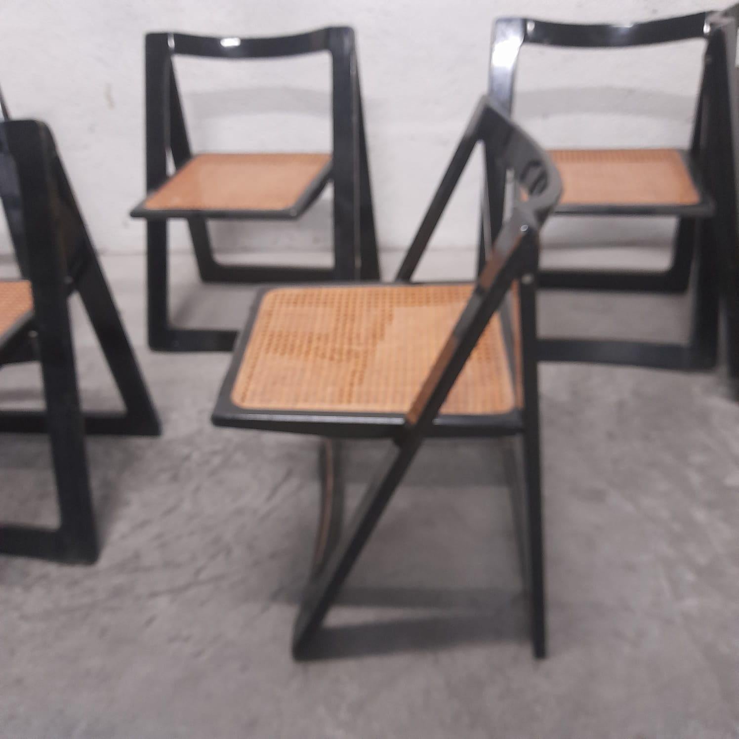 Set of 6 Italian folding Trieste Chairs by Jacober and D'aniello for Bazzani in black lacquered wood with original Vienna Straw seats.
One of the seats must be replaced; the replacement is included in the cost of the set.