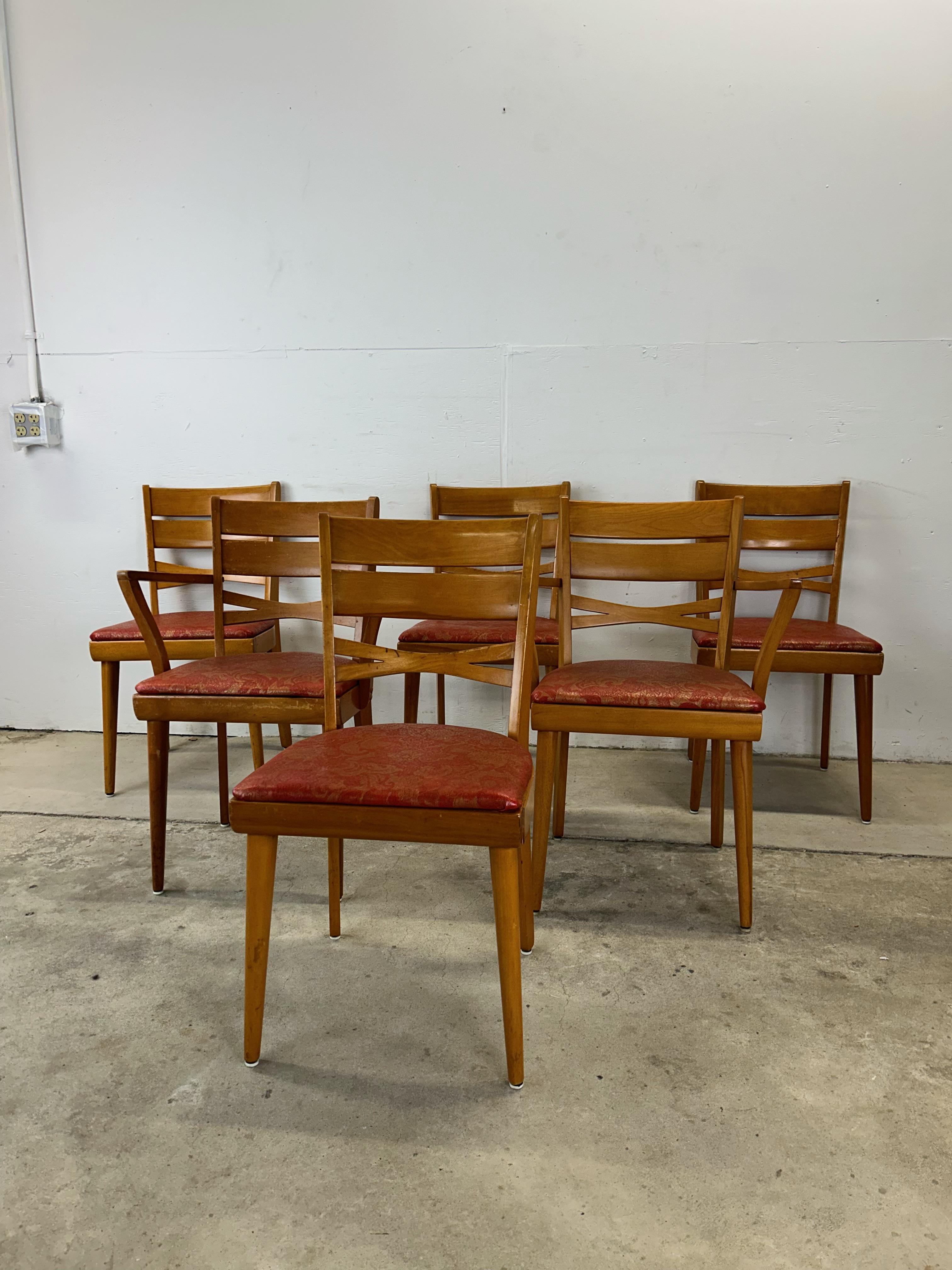 This set of six mid century modern dining chairs in the style of Heywood Wakefield feature hardwood construction, original maple finish, vintage red patterned uphosltery, two arm chairs and four side chairs with tall tapered legs.

Matching maple