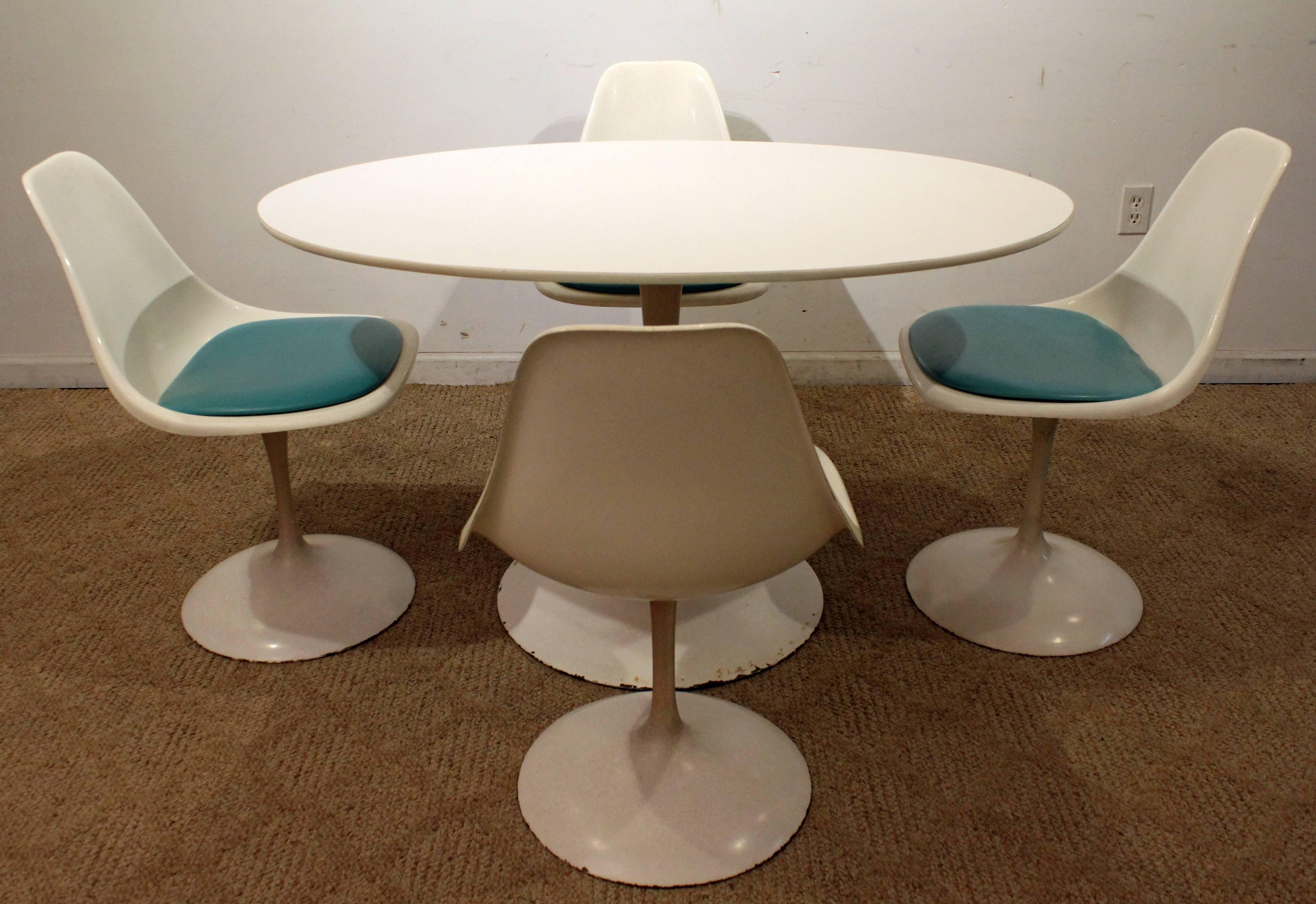 Offered is a Saarinen style dining set, including a tulip dining table and set of four tulip chairs. They are similar to the style of Eero Saarinen's Tulip dining set. Signed by Contemporary Shells Inc.

Measure: Table: 48