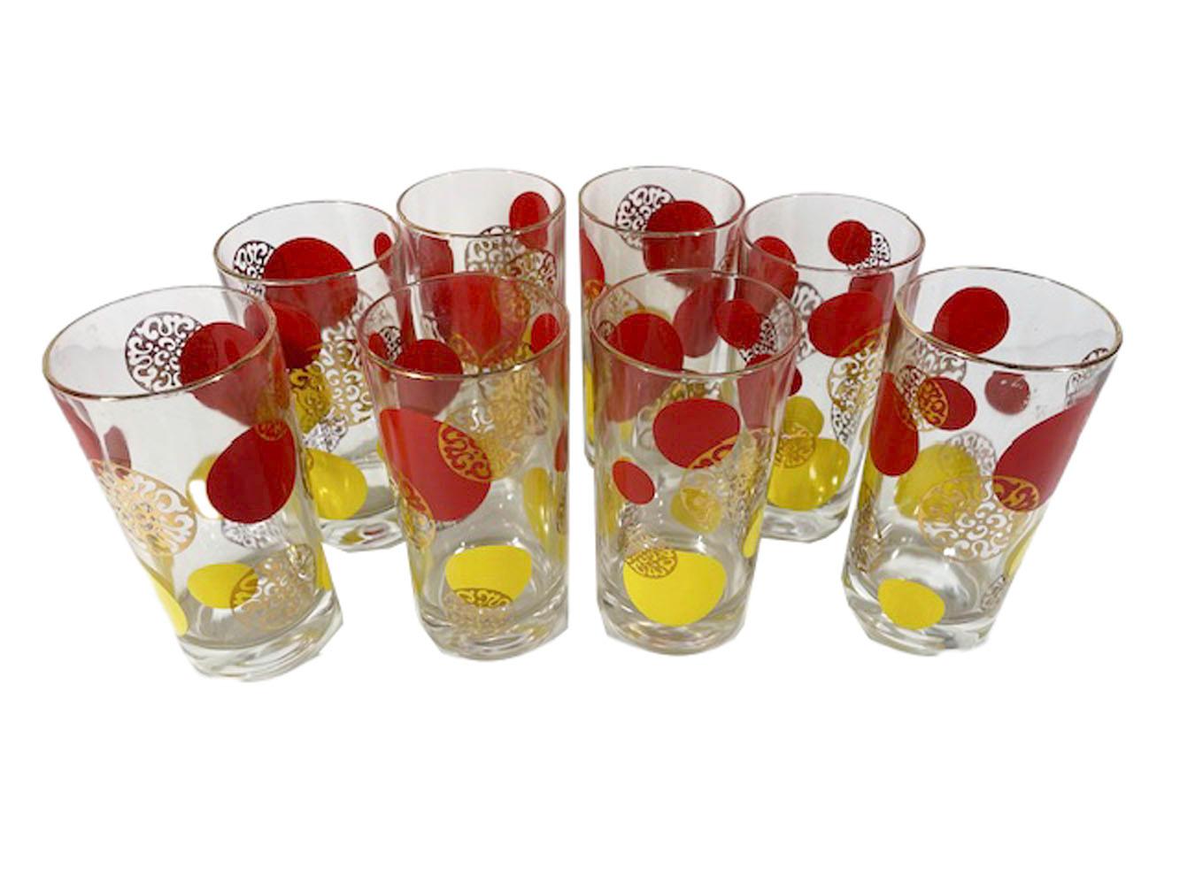 Set of eight Mid-Century Modern highball glasses with red and yellow enamel circles of various sizes along with 22k gold filigree medallions.