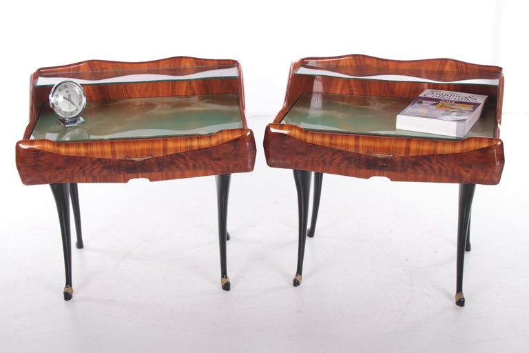 A beautiful pair of Mid-Century Modern nightstands by the Italian designer Paolo Buffa.

They have a semi-floating clear glass top on top of a 