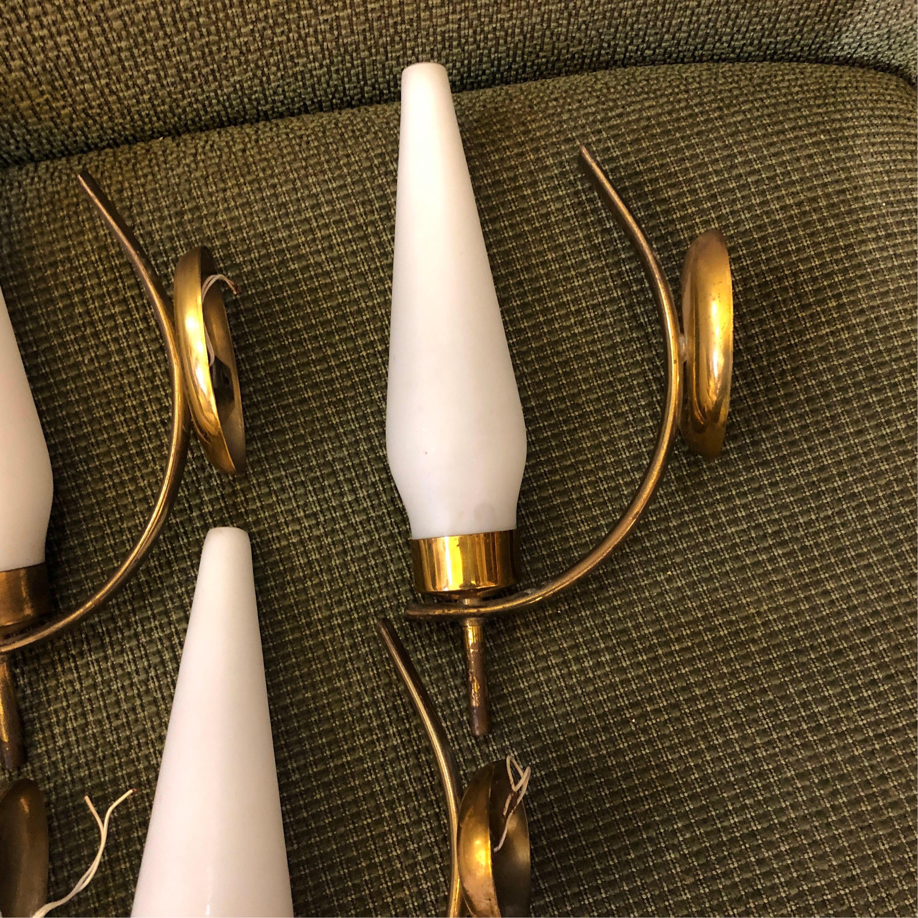 Four Mid-Century Modern wall sconces in the manner of Stilnovo, brass is in original patina, they work 110-240 volts and need regular e14 bulbs. Brass is in original patina, but it's an easy material to clean and return to perfect conditions.