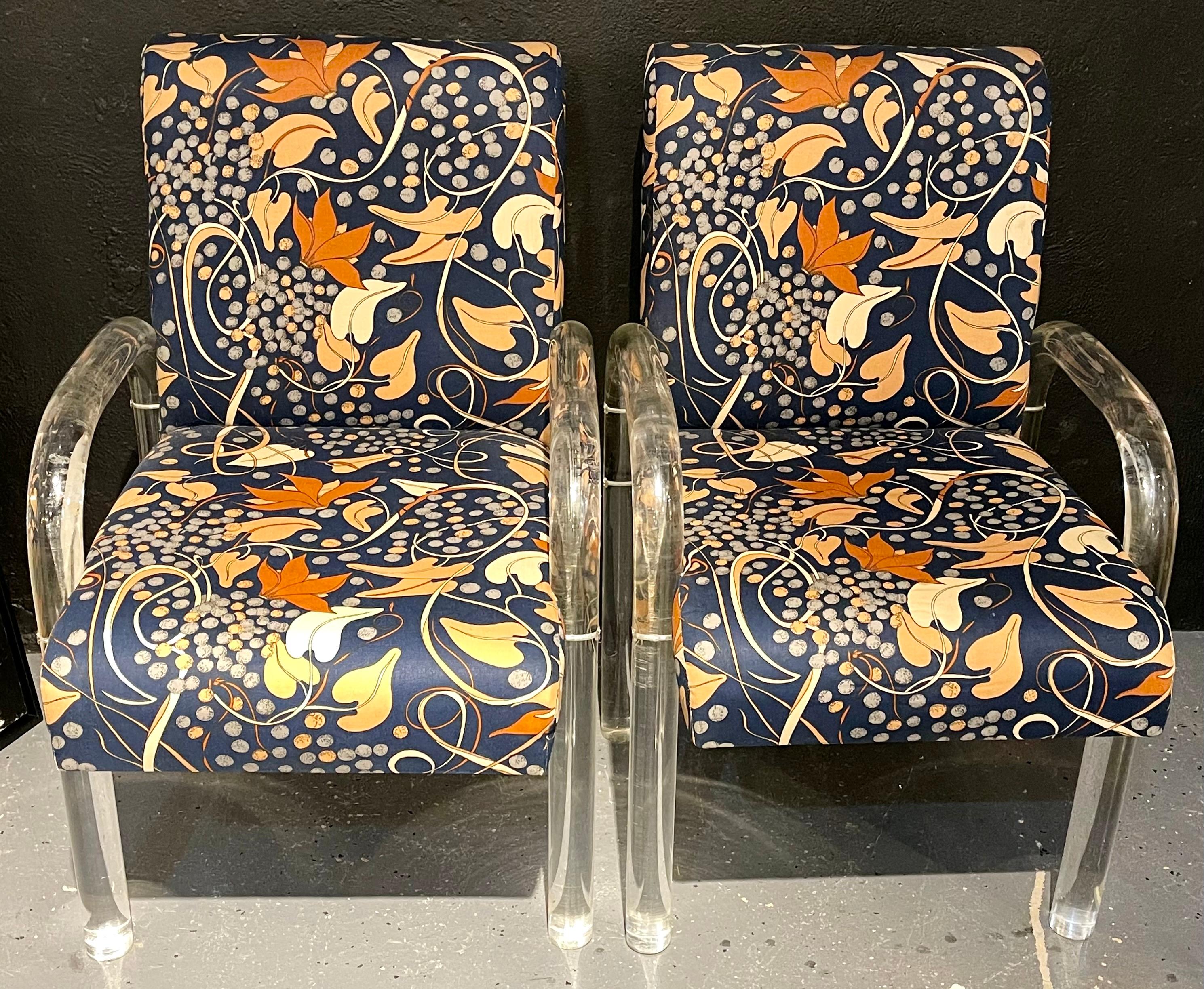 Set of 4 tubular Lucite dining chairs most likely by Lion in Frost. A timeless design of thick Lucite legs and sloped arms each in a lovey clean Floridian fabric. Can purchase one or all four as needed.