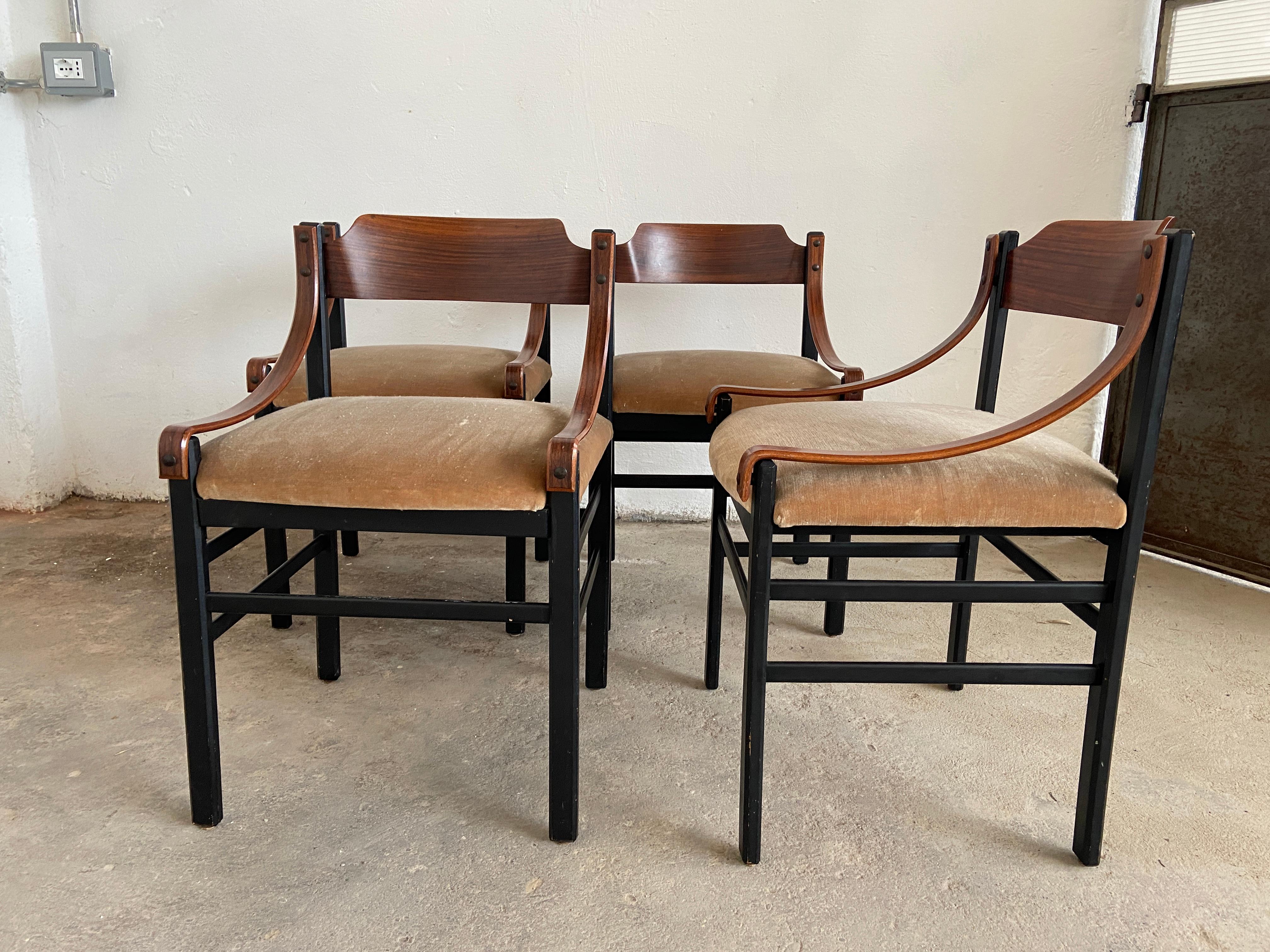 Mid-Century Modern Danish set of four dining room mahogany chairs with original upholstery. 
The chairs are in really good vintage conditions. 
The back of one piece shows traces of age and use (see photo).
 