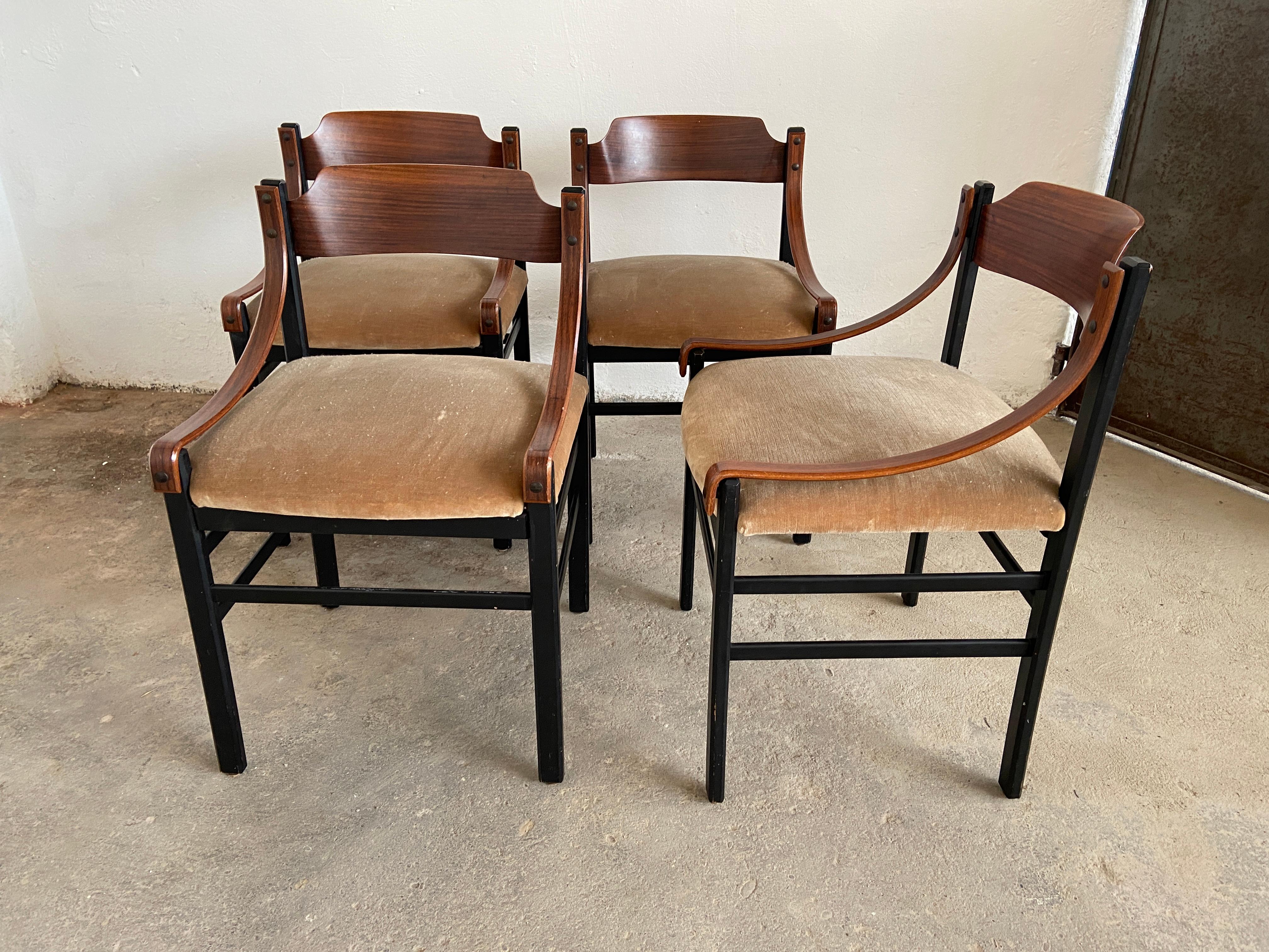 Mid-Century Modern Danish set of four dining room mahogany chairs with original upholstery. 
The chairs are in really good vintage conditions. 
The back of one piece shows traces of age and use (see photo).
 