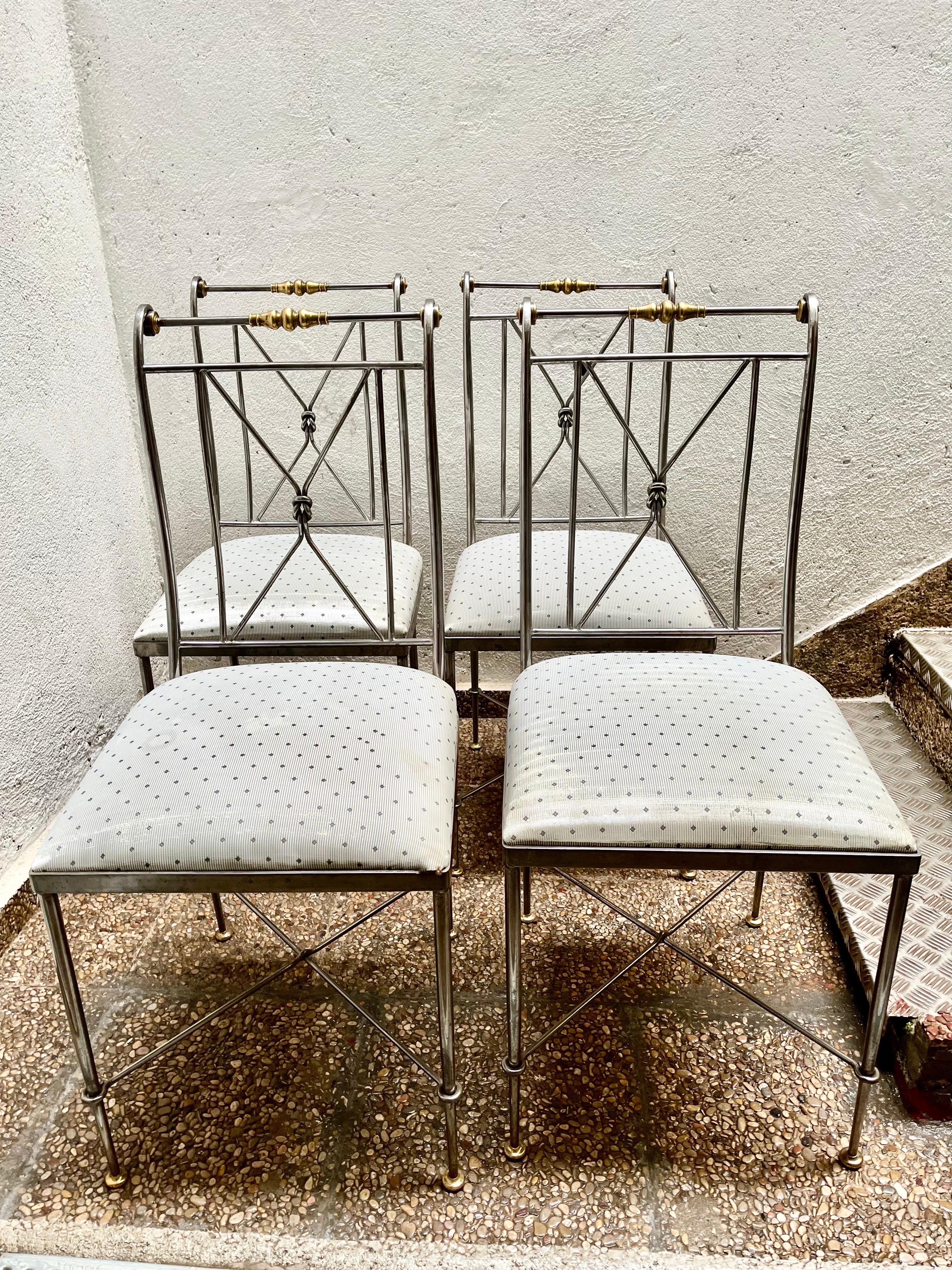 A set of four chairs from the 1970s, made by Alberto Orlandi in Italy.
They are made of polished steel and solid gilded brass, the chairs in a neoclassical style have elegant curved backrests, with a steel interlacing, and slender legs that end in a