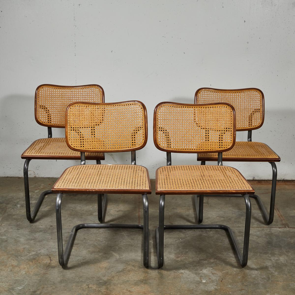 Mid-Century Modern set of four vintage caned metal dining chairs.