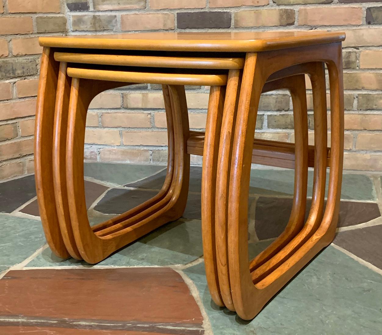 For your consideration is a phenomenal set of nesting tables, including three side tables that fit into one another, by Nathan Mastercraftsman, circa the 1960s. In excellent vintage condition. The largest table measures 21