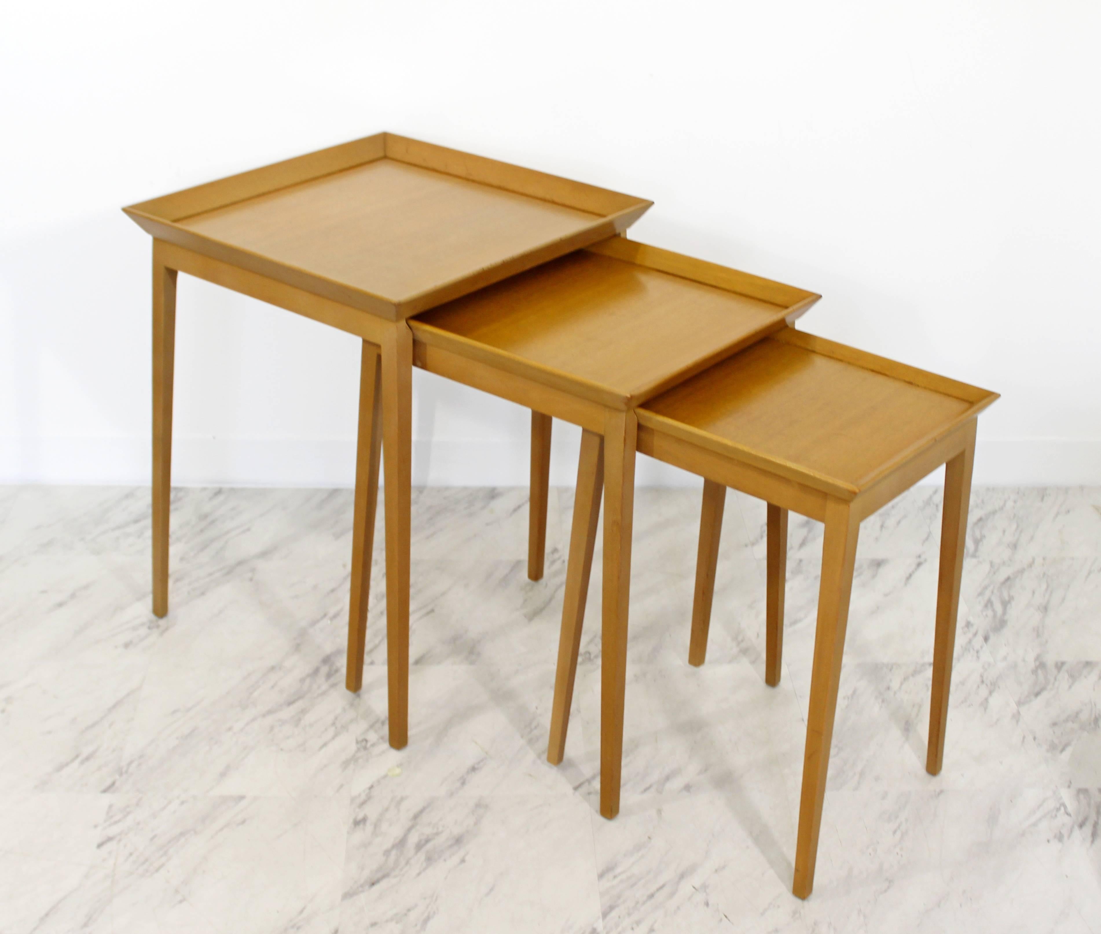 For your consideration is a gorgeous set of nesting table, including three side tables that fit into one another, by T.H. Robsjohn-Gibbings for Widdicomb, circa the 1950s. In excellent condition. The largest table measures 19.75