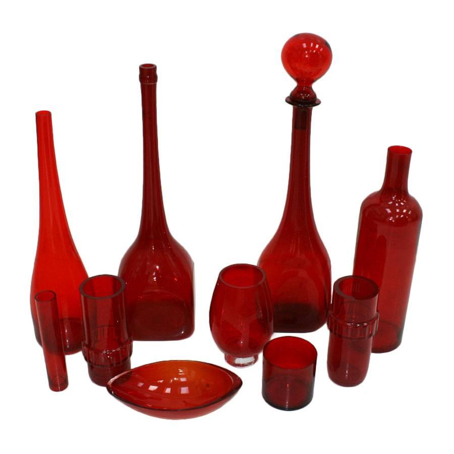Set of ten Italian vases made of red blow Murano glass. The set contains ten different size pieces including bottles and vases. The height measuring is between 8-90cm. Good vintage condition.


 