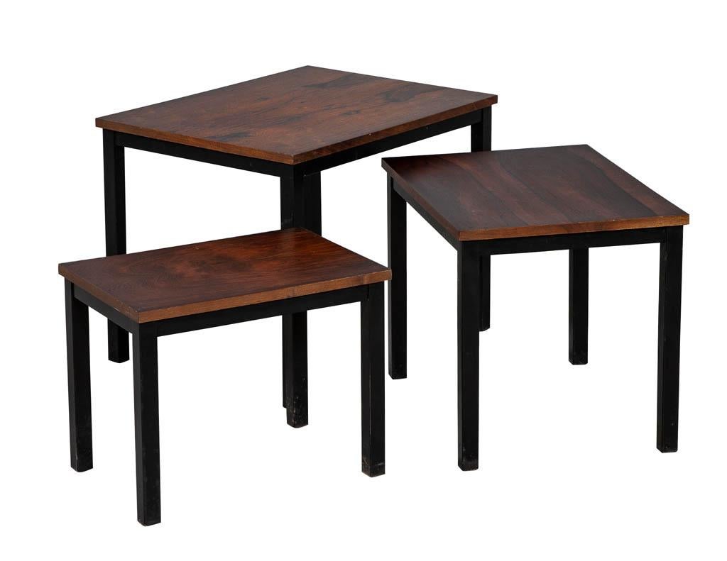 Mid-Century Modern set of three nesting tables. Featuring wood tops and ebonized bases, circa 1960s from Denmark, Europe. In original condition – wear consistent with age and use. 

Large: H 20” x W 26” L 20” 
Medium: H 18” x W 22” x L