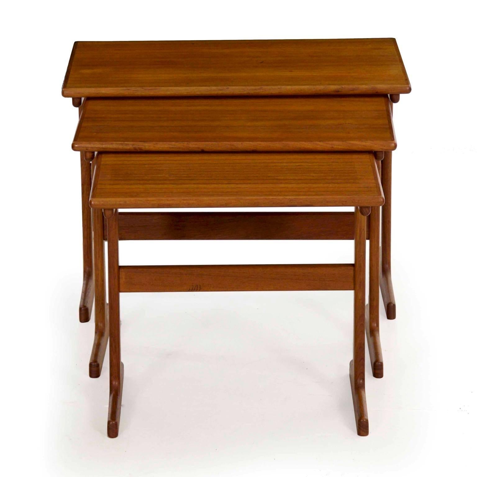 This is a very nice Danish Mid-Century Modern trio of nesting tables designed by Kai Kristiansen and executed by Vildbjerg Møbelfabrik in teak during the 1960s. The smallest table retains the brand to the underside “VM Made in Denmark”. They are an