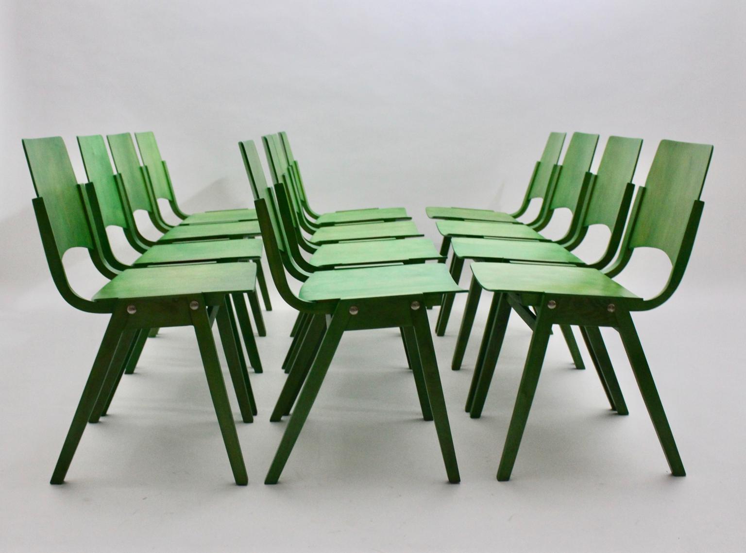 Mid Century Modern vintage set of 12 beech green vintage dining chairs model no. P7, which are also stackable, designed by Roland Rainer for the Viennese Stadthalle (backstage area) 1952 and executed by Emil & Alfred Pollak Vienna.
These vintage