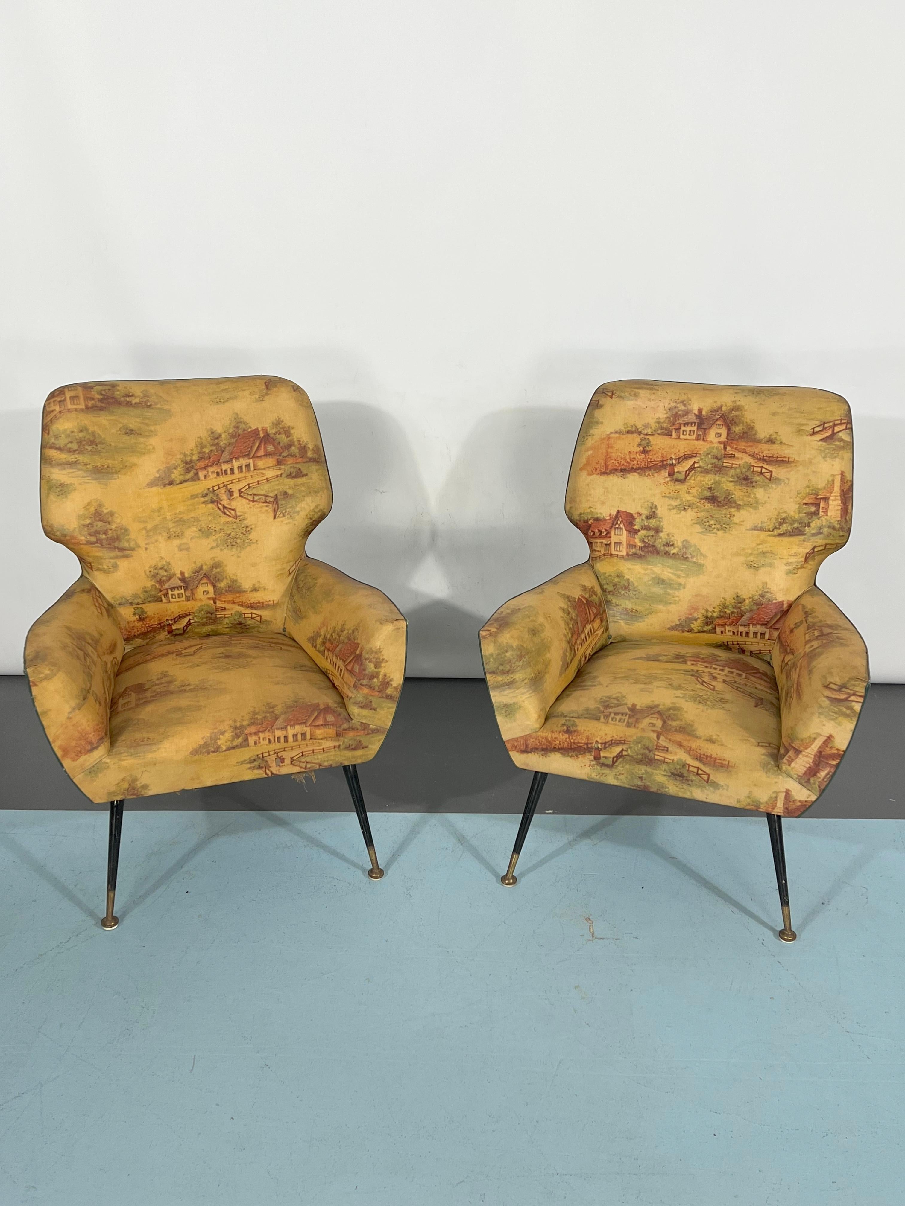 Vintage condition with original fabric for this set of two armchairs produced in Italy during the 1950s. They mount brass feet. Evident trace of age and use and some defects on the fabric.