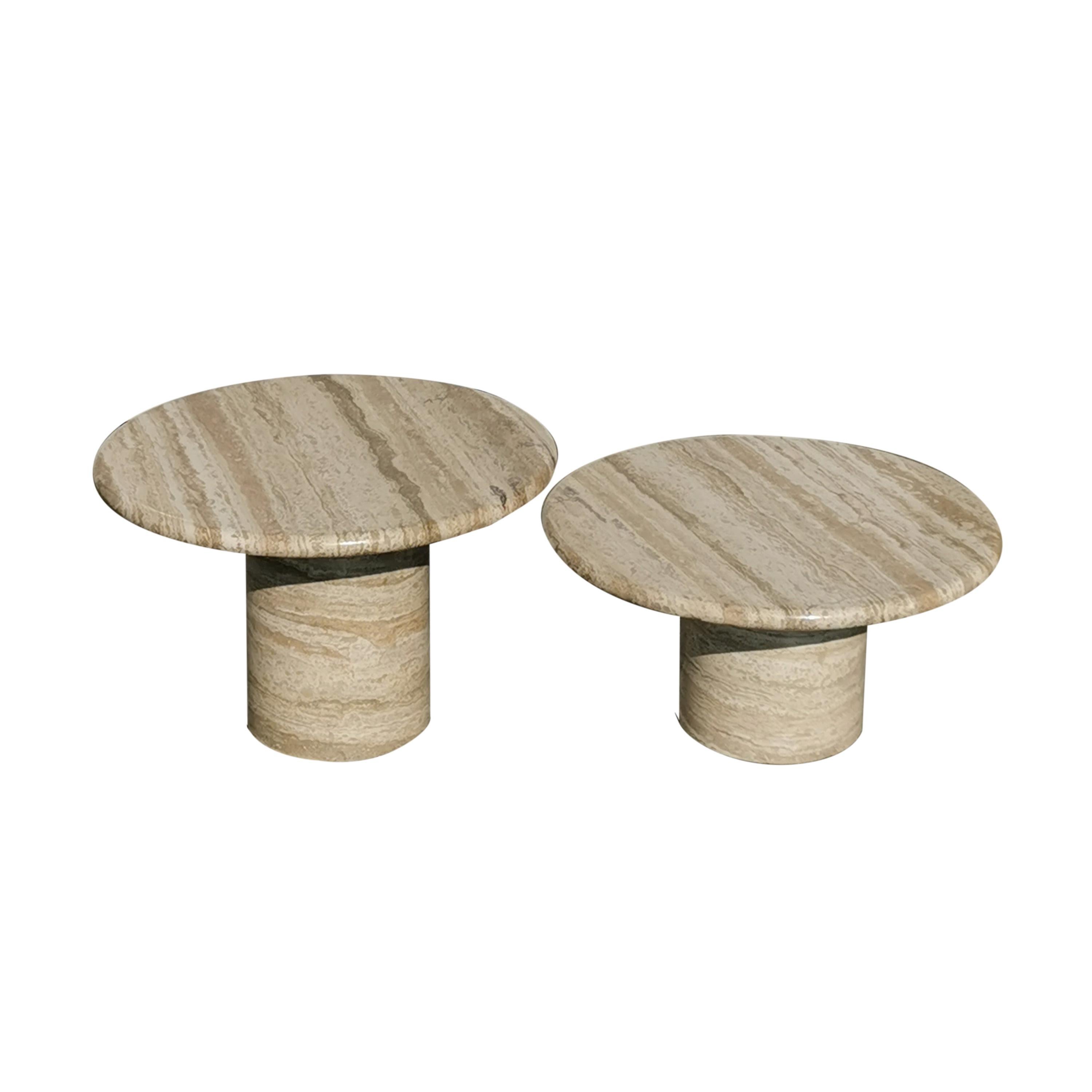 Set of two cream travertine coffee tables.
Round top with gently curved edge, resting on a cylindrical pedestal leg.
Made in Italy during the seventies.
The puristic play of the volumes make this set timeless.
Very nice condition.