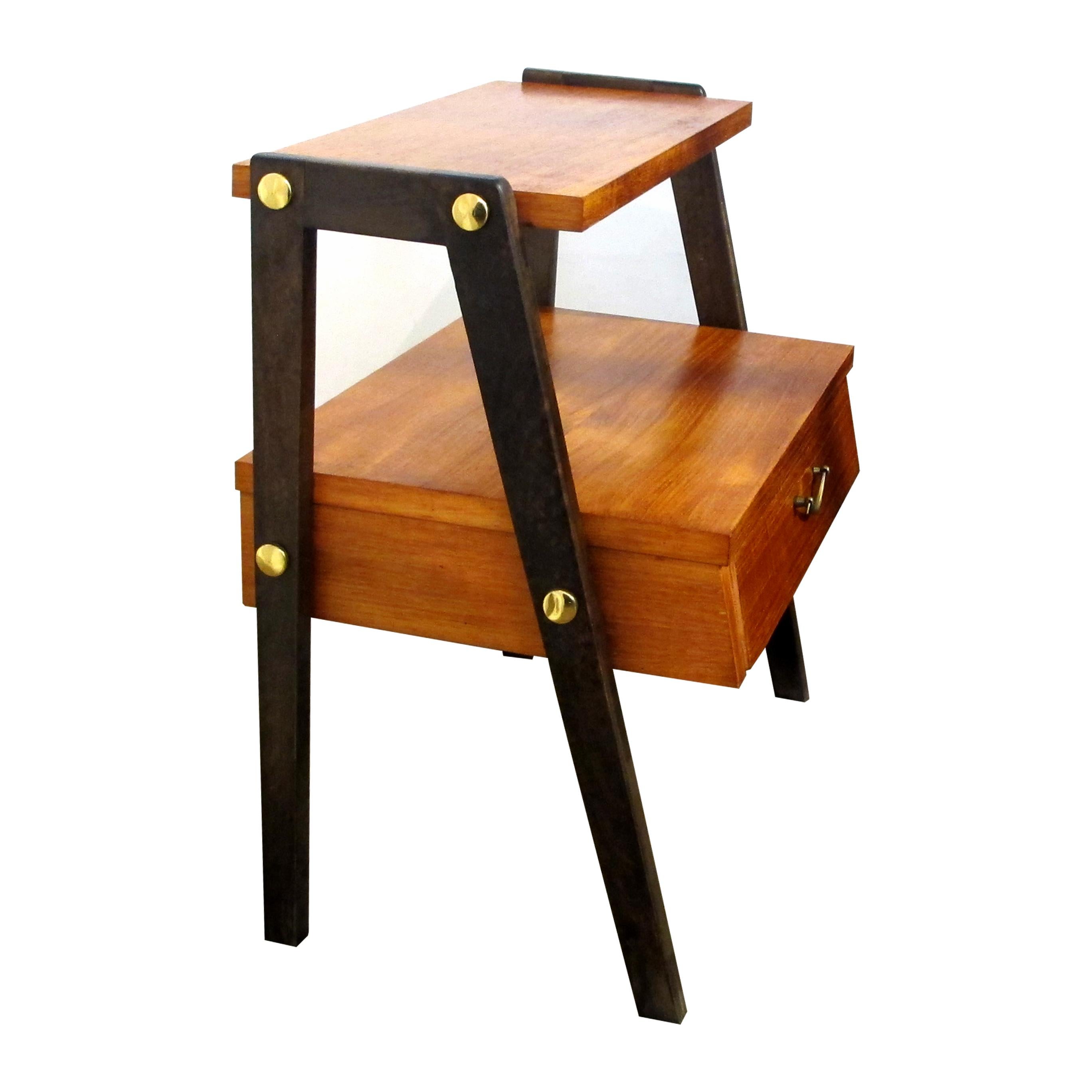 Pair of compact Scandinavian two-tier teak bedside tables, 1950s. These nightstands are ideal for small spaces, each table has one drawer and two shelves. The tables are presented on darker brown painted legs creating an elegant contrast to the