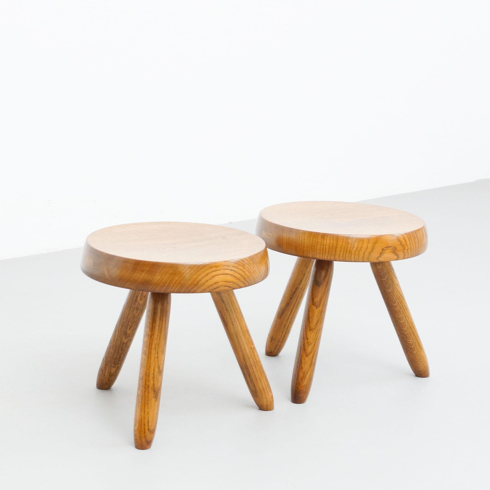 Stools designed in the style of Charlotte Perriand.
Made by unknown manufacturer.

In good original condition, preserving a beautiful patina, with minor wear consistent with age and use. 

Materials:
Wood

Dimensions:
31 D cm x 31 W cm x