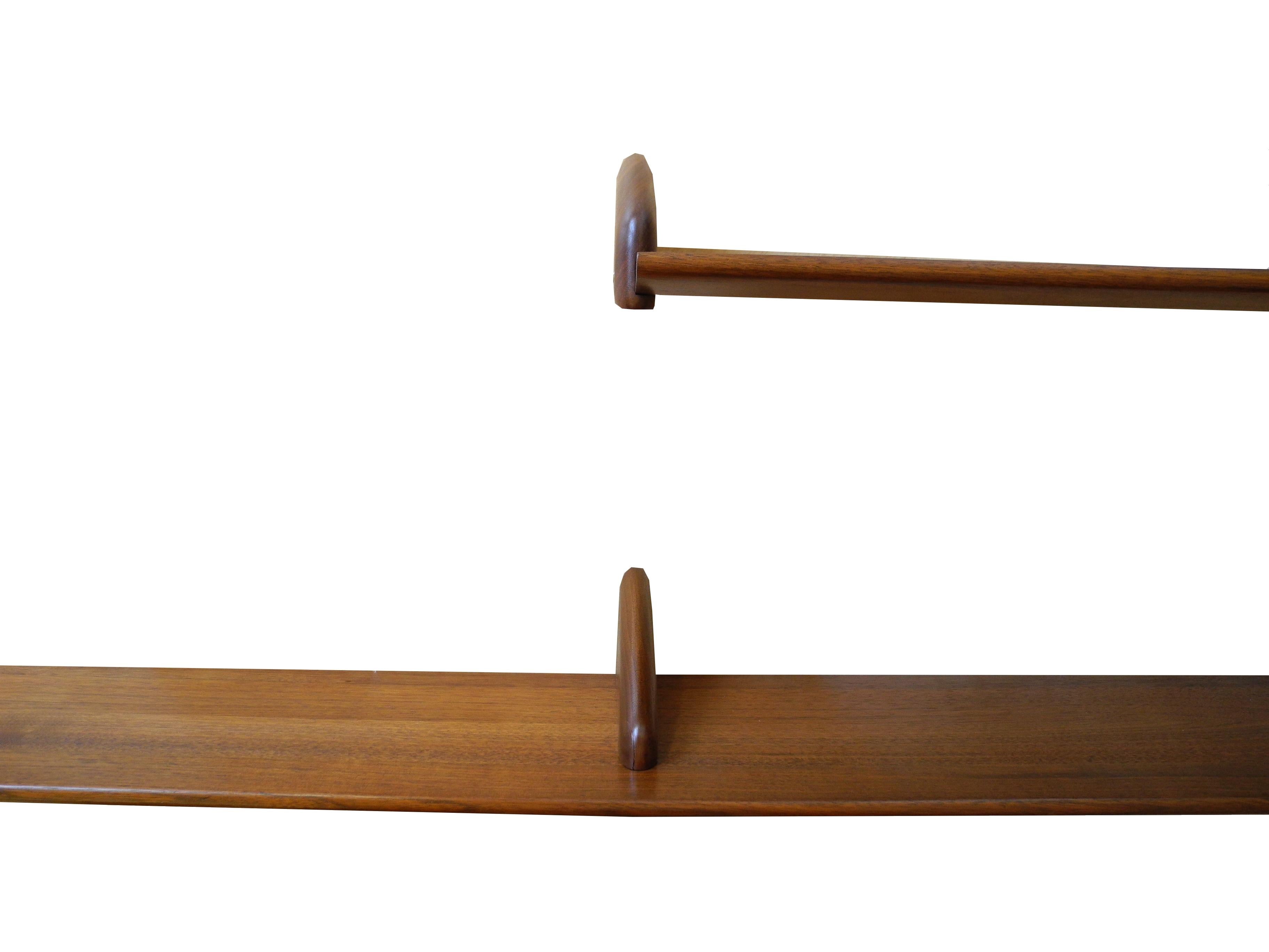 These refinished vintage walnut shelves measure 6 feet and 3 feet. Place and design anywhere on the wall. Each shelf has hidden hanging hardware on the back or wall side for a sleek floating look. Book ends are built into the design.
 