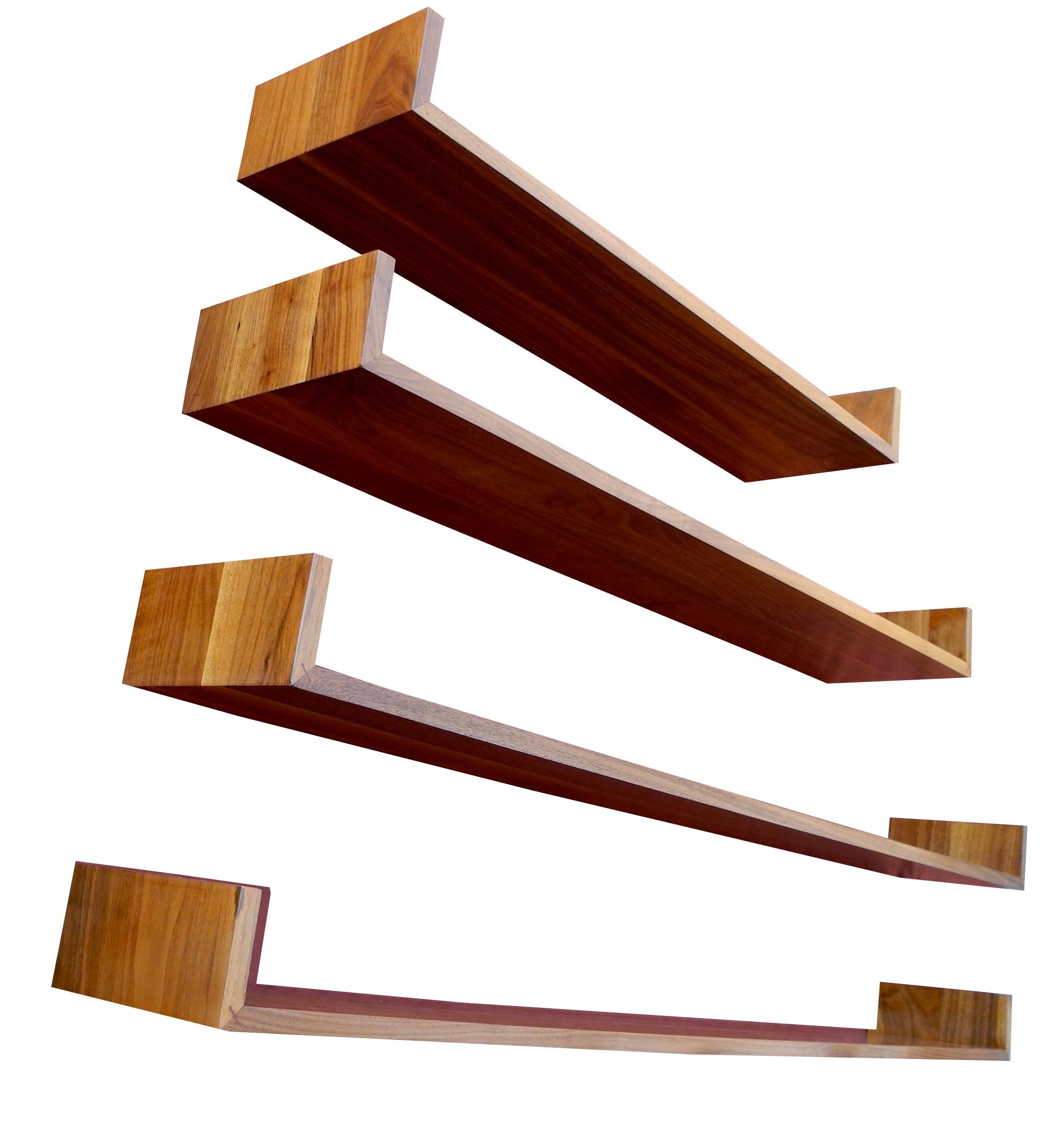 This handsome set of modern walnut hanging shelves can be placed at any height on your wall. Designed by Mel Smilow, they create a floating affect on the wall. Strong enough for books. This set contains two shelves at 60 