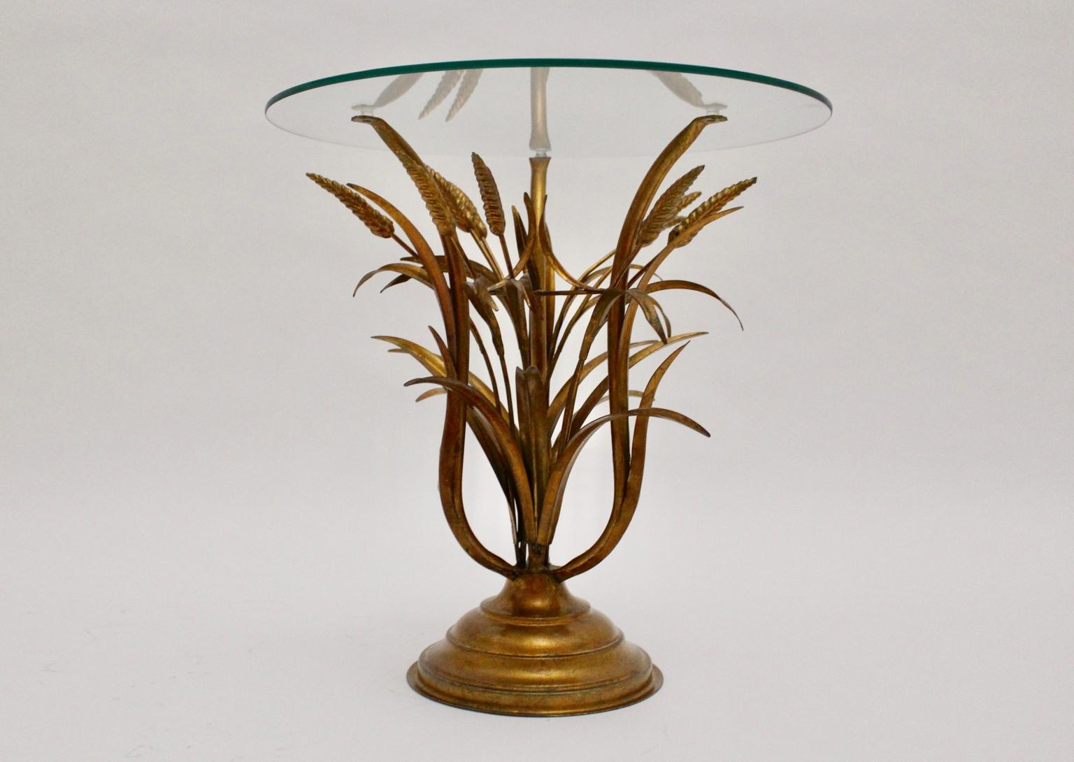 Mid Century Modern vintage Hollywood Regency style coffee table features a gold-plated metal base sheaf of wheat like.
Topped with a round clear glass plate.
Very good condition with signs of age and use.

approx. measures: Diameter: 45 cm
Height: