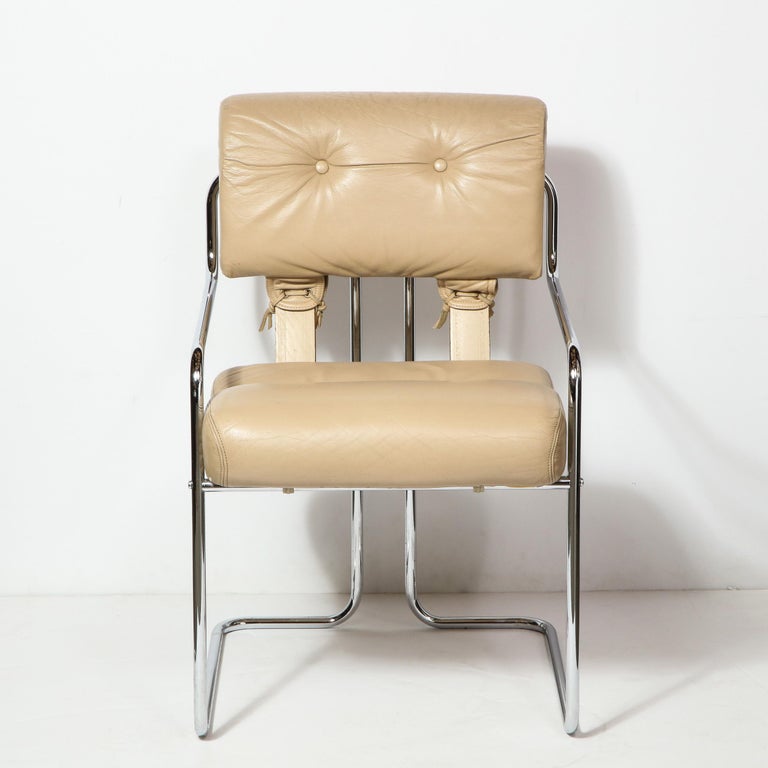 This bold and elegant Mid-Century Modern side/ occasional was realized by Guido Faleschini for Pace Collection, in Italy circa 1970. The arm chair features a tubular bent chrome frame- full of sinuous curves- that support button-tufted leather
