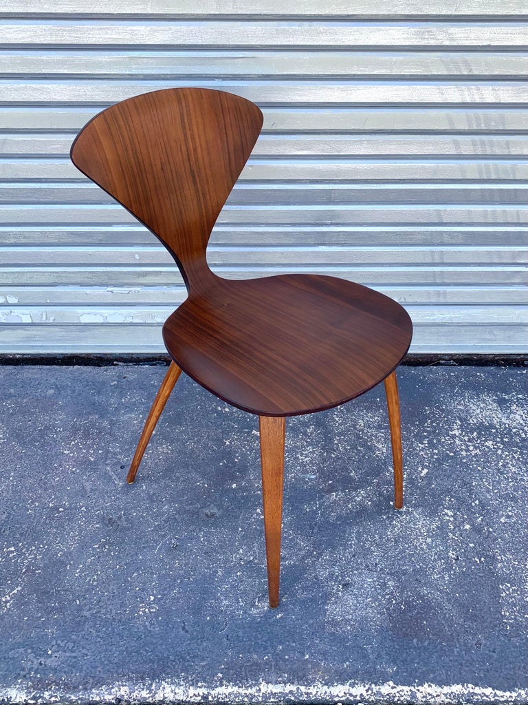Early example of Norman Cherner’s “pretzel” chair designed for Plycraft. In beautiful original condition and original walnut finish. Delicately made with plys of strong wood demonstrating beautiful curves and angles. 

These chairs were