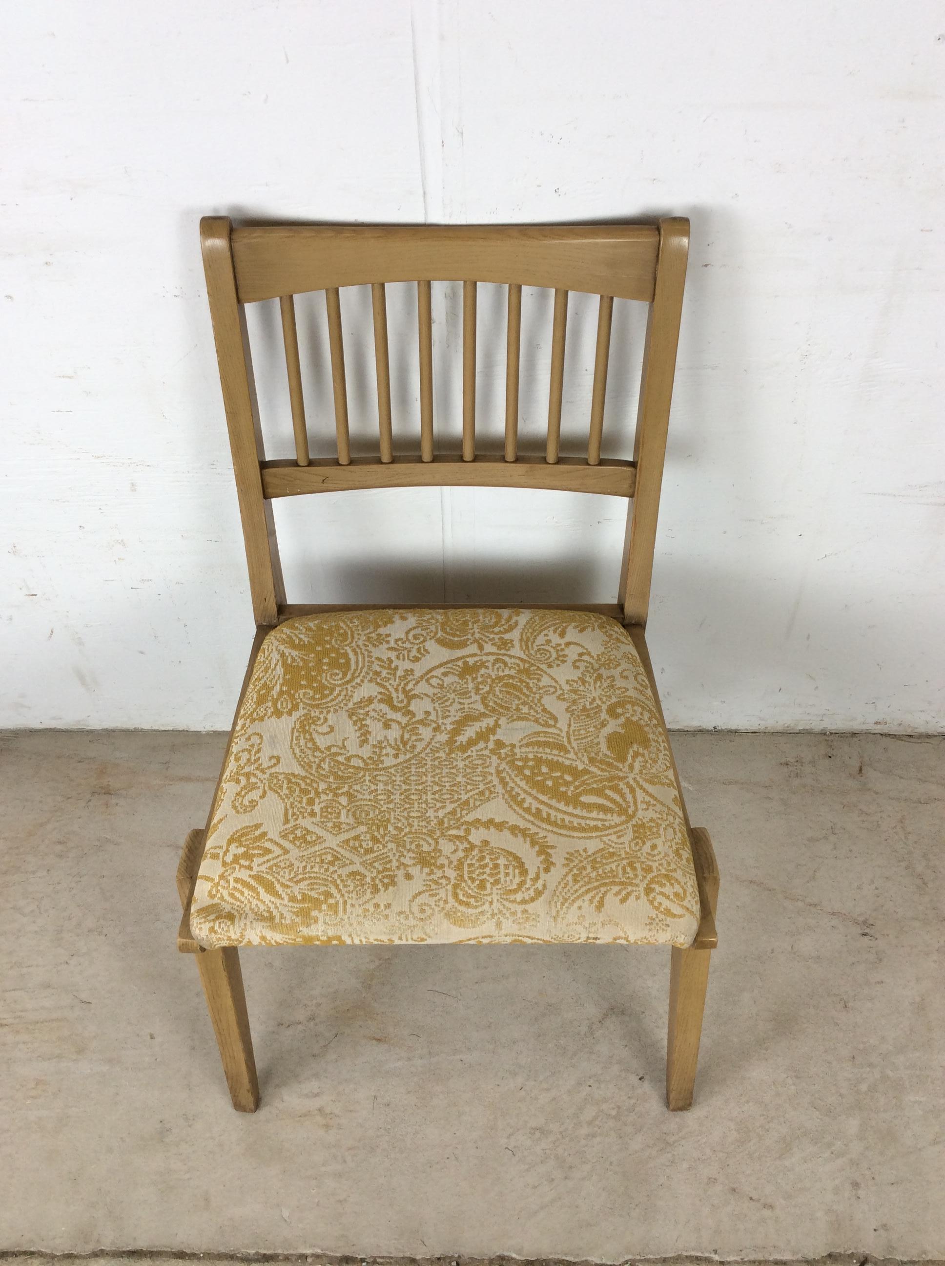 This mid century modern side chair features hardwood construction, original limed oak finish, newer patterned upholstery, and spindled seat back.

Dimensions: 21w 21d 32.5h 17sh 

Condition notes: Original finish has slight scuffs, small scratches,
