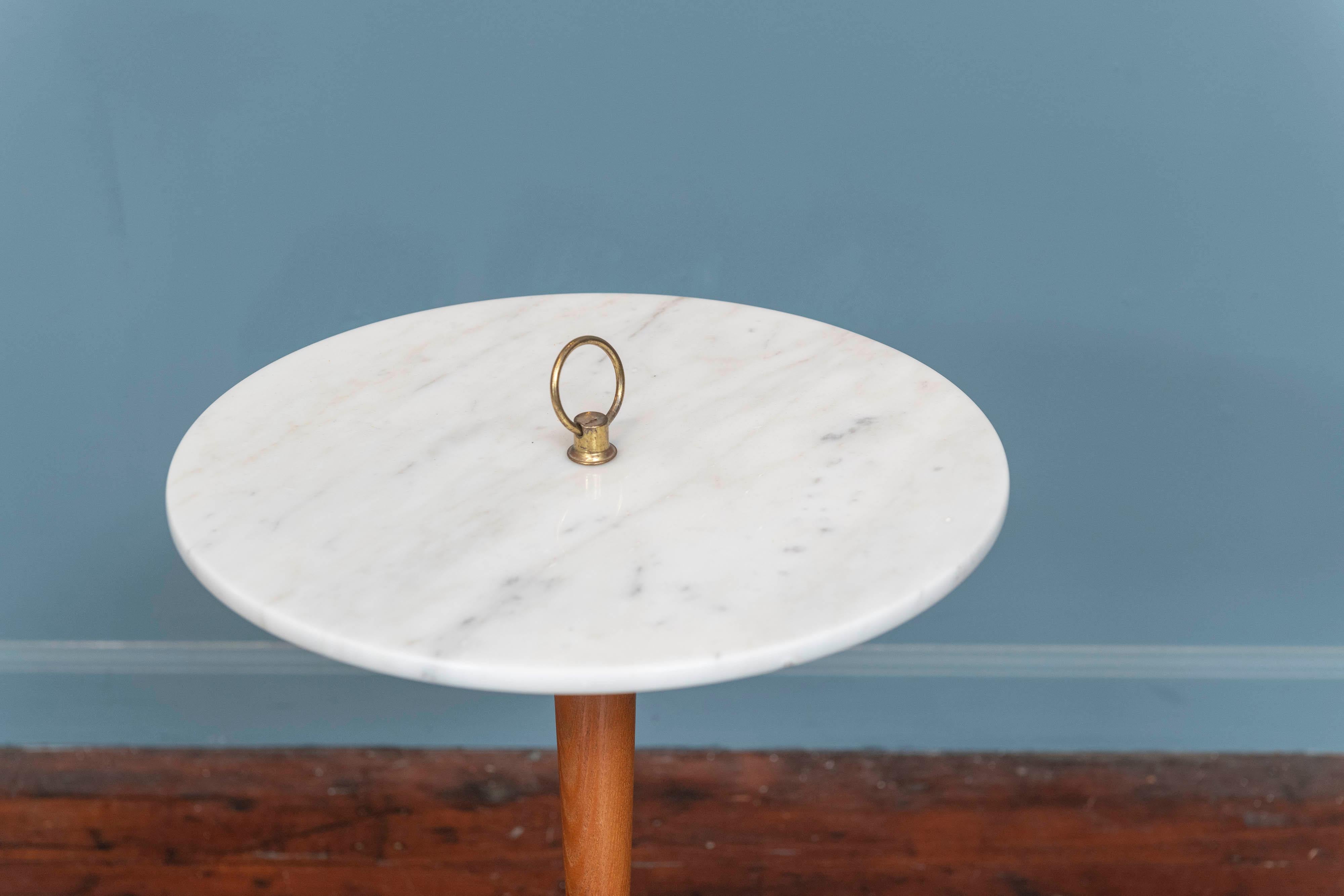 Mid-Century modern side table with a polished marble top on a turned pedestal and gilt form propeller base.