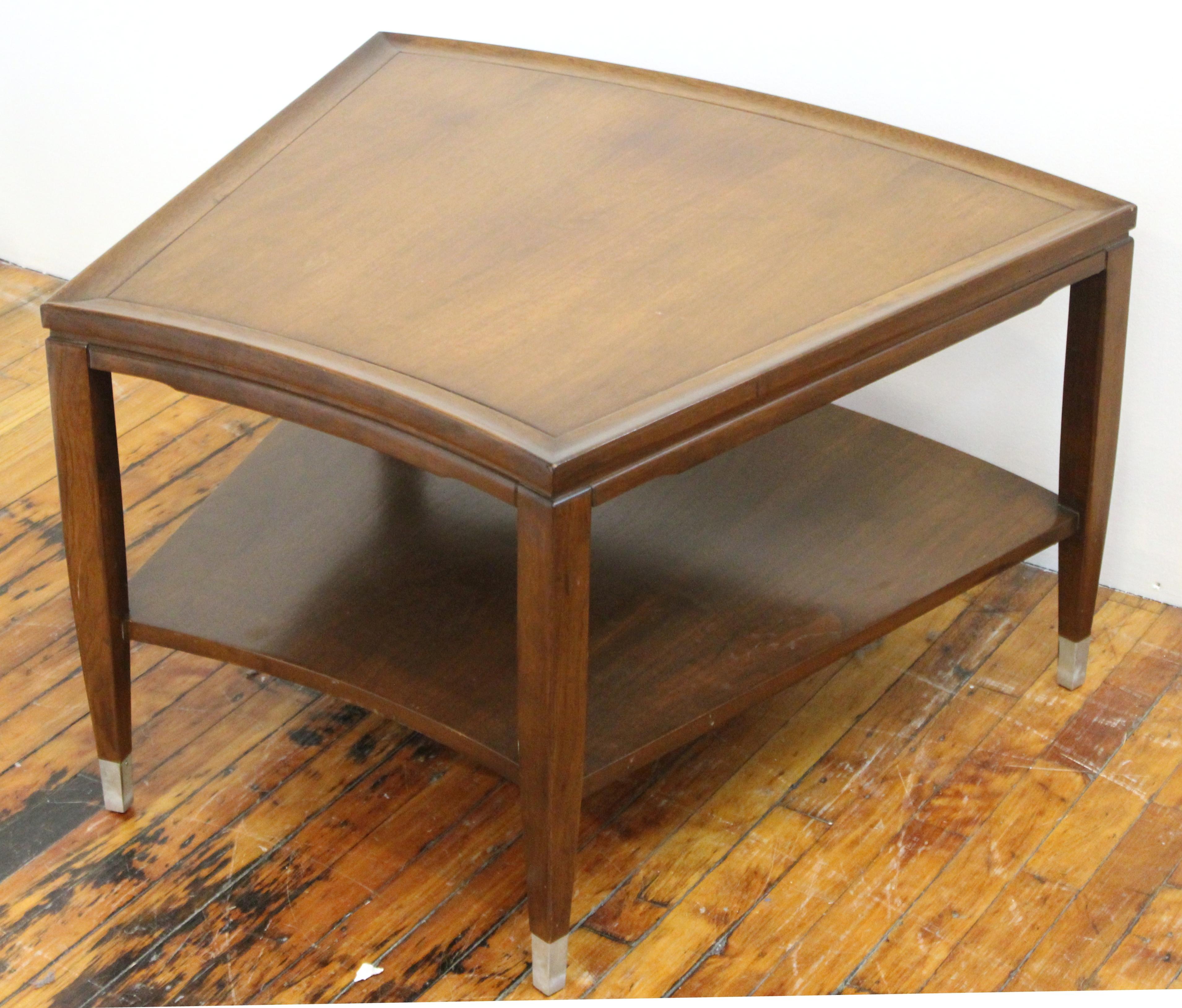 Mid-Century Modern two-tiered side table or corner table with a slightly angled shape and metal covered feet. The piece is in great vintage condition, with age-appropriate wear.