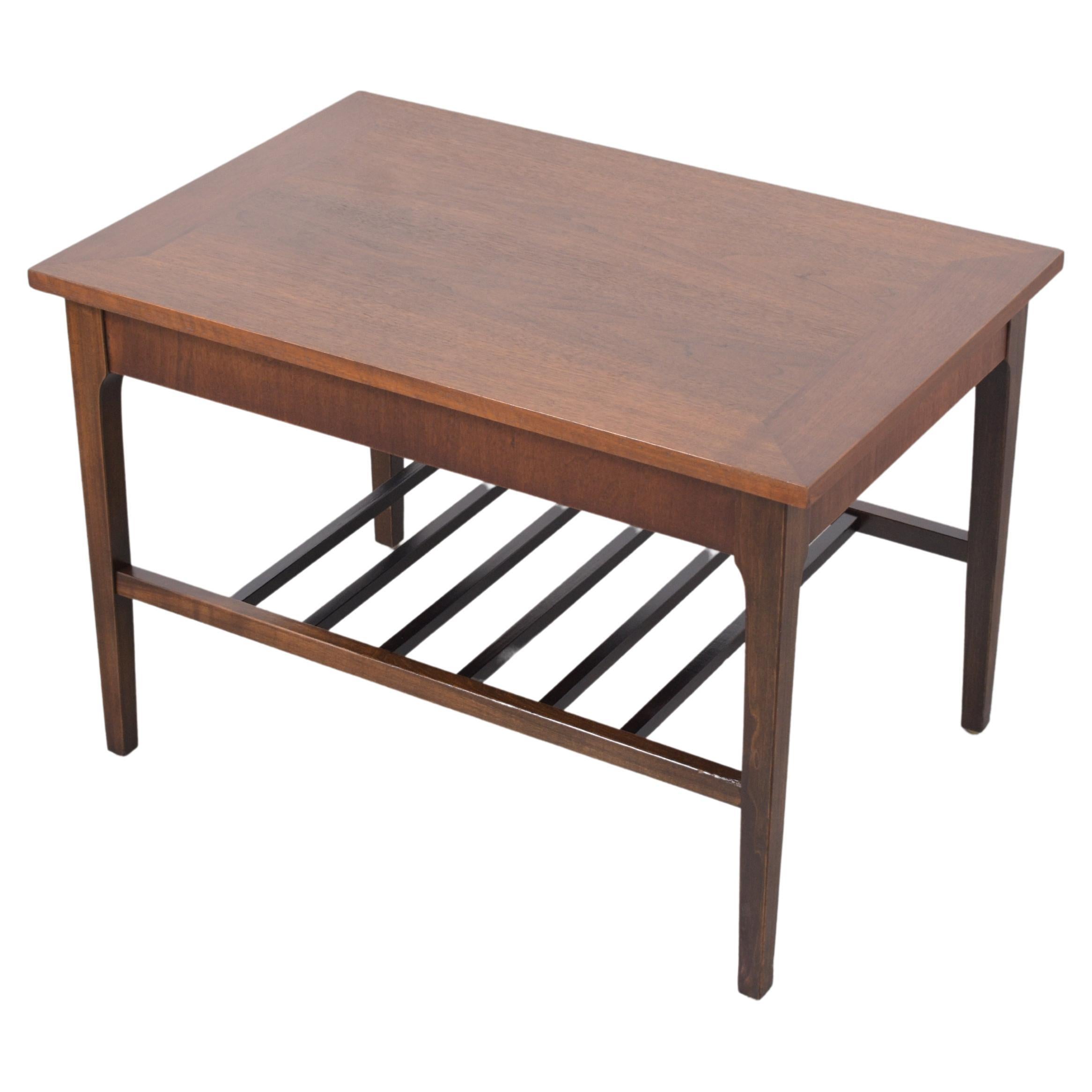 Discover our extraordinary 1960s mid-century modern side table, beautifully hand-crafted from quality walnut wood and meticulously restored by our expert craftsmen. This exceptional accent piece features a rich blend of walnut and ebonized color