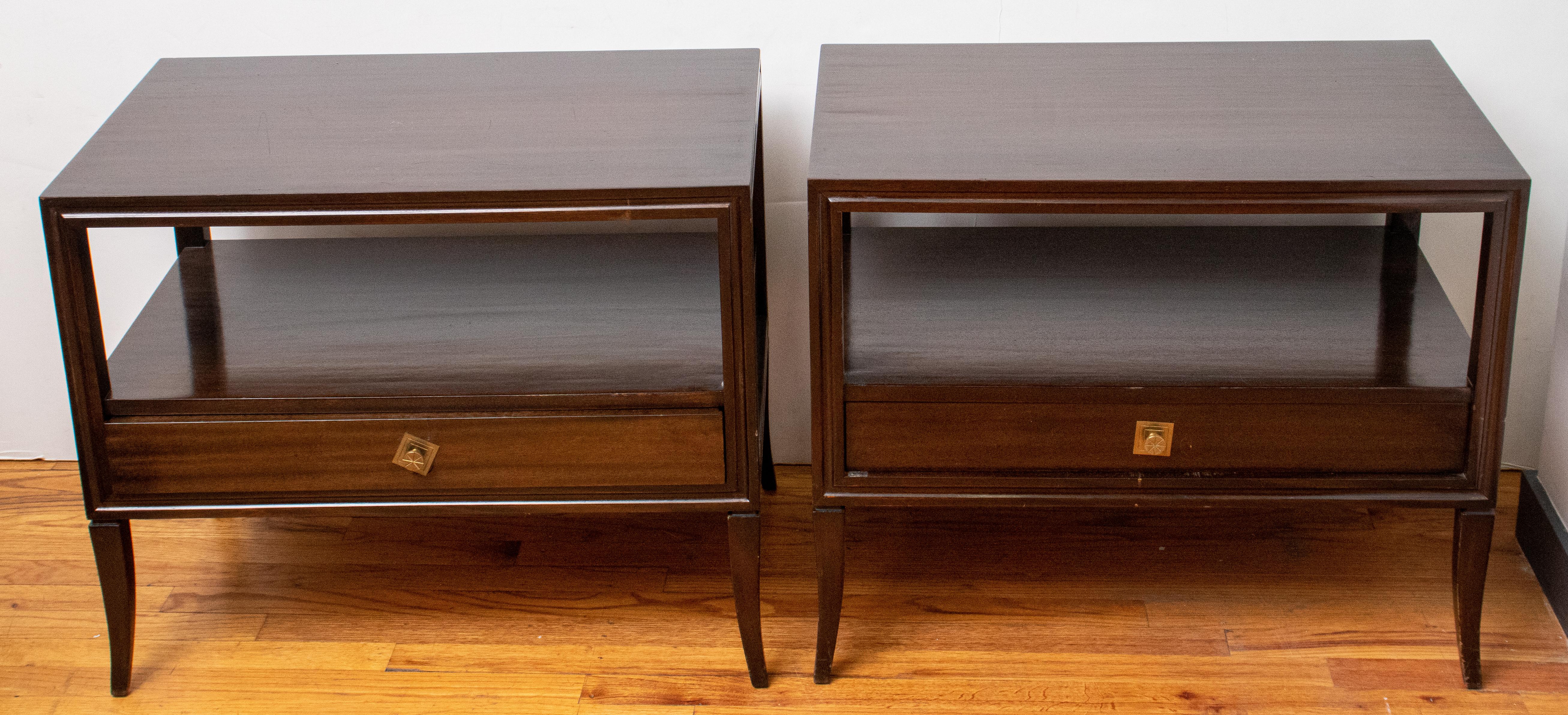 Pair of Mid-Century Modern brown wood nightstands or side tables, each with one drawer with brass pull, unmarked. 
Measures: 23