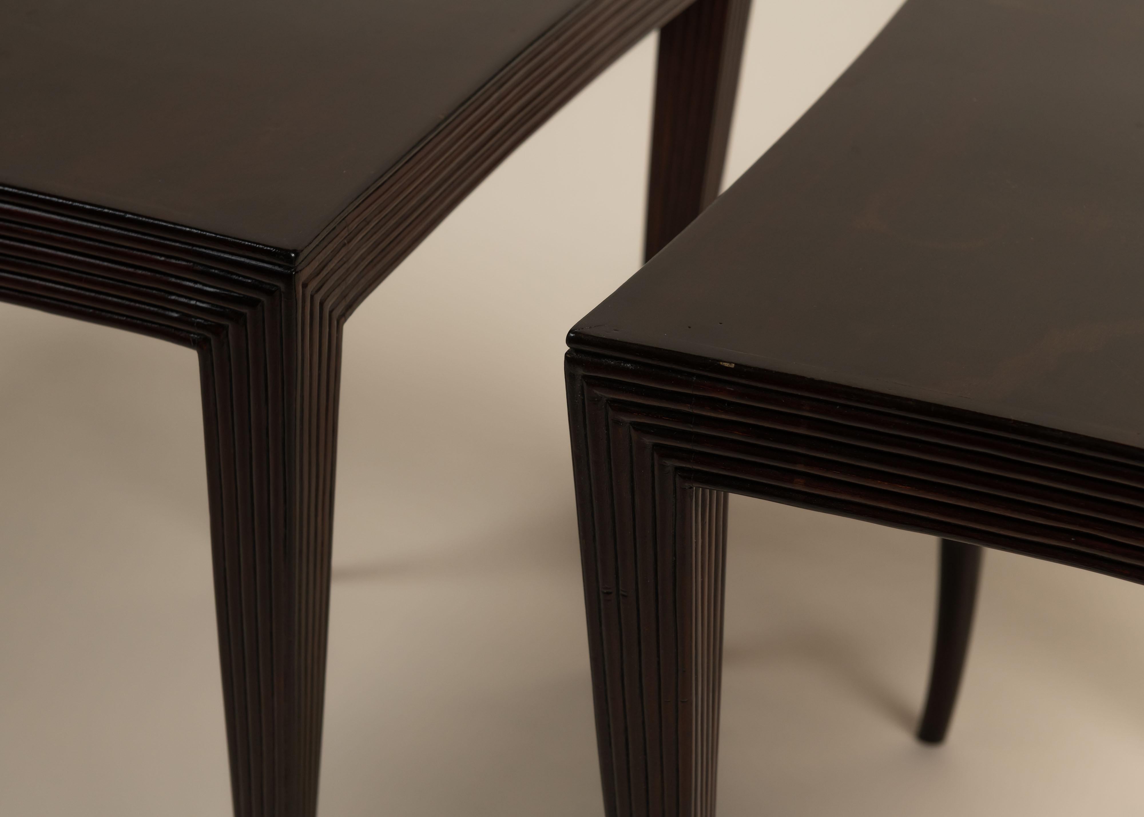This pair of side tables features gently curved, tapering legs and fluted aprons that wrap the corners in a sculptural design. Made from dark-stained wood with a soft sheen, they blend Art Deco style with modern simplicity. Elegant and versatile,