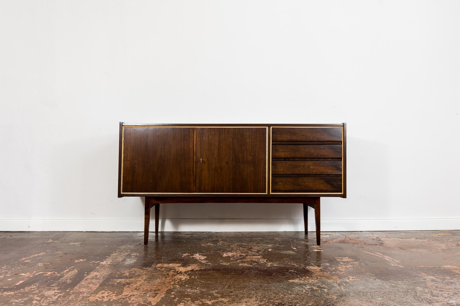 Sideboard designed by Stanisław Albracht for Bydgoskie Furniture Factories, 1960's, Poland.
This item has been restored and refinished enhancing unique contrasting colors of mahogany veneer.
Sideboard has 2 sliding doors, removable shelf and 4