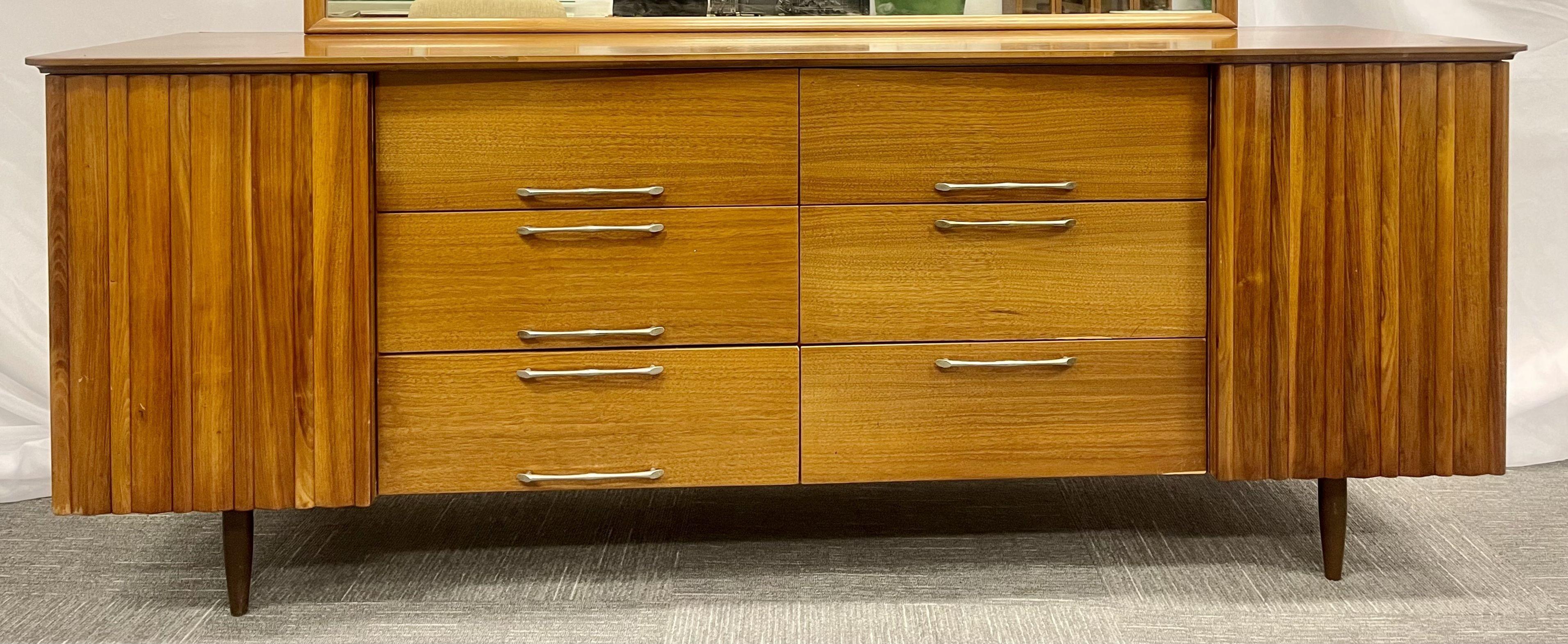 Mid-Century Modern sideboard, dresser, attached mirror, bedroom set, vanity

A fine walnut dresser having six center drawers flanked by doors with fitted drawer interiors on tapering legs.

Mirror size: 31 in. H x 61.25 in. W x 2 in. D
Overall