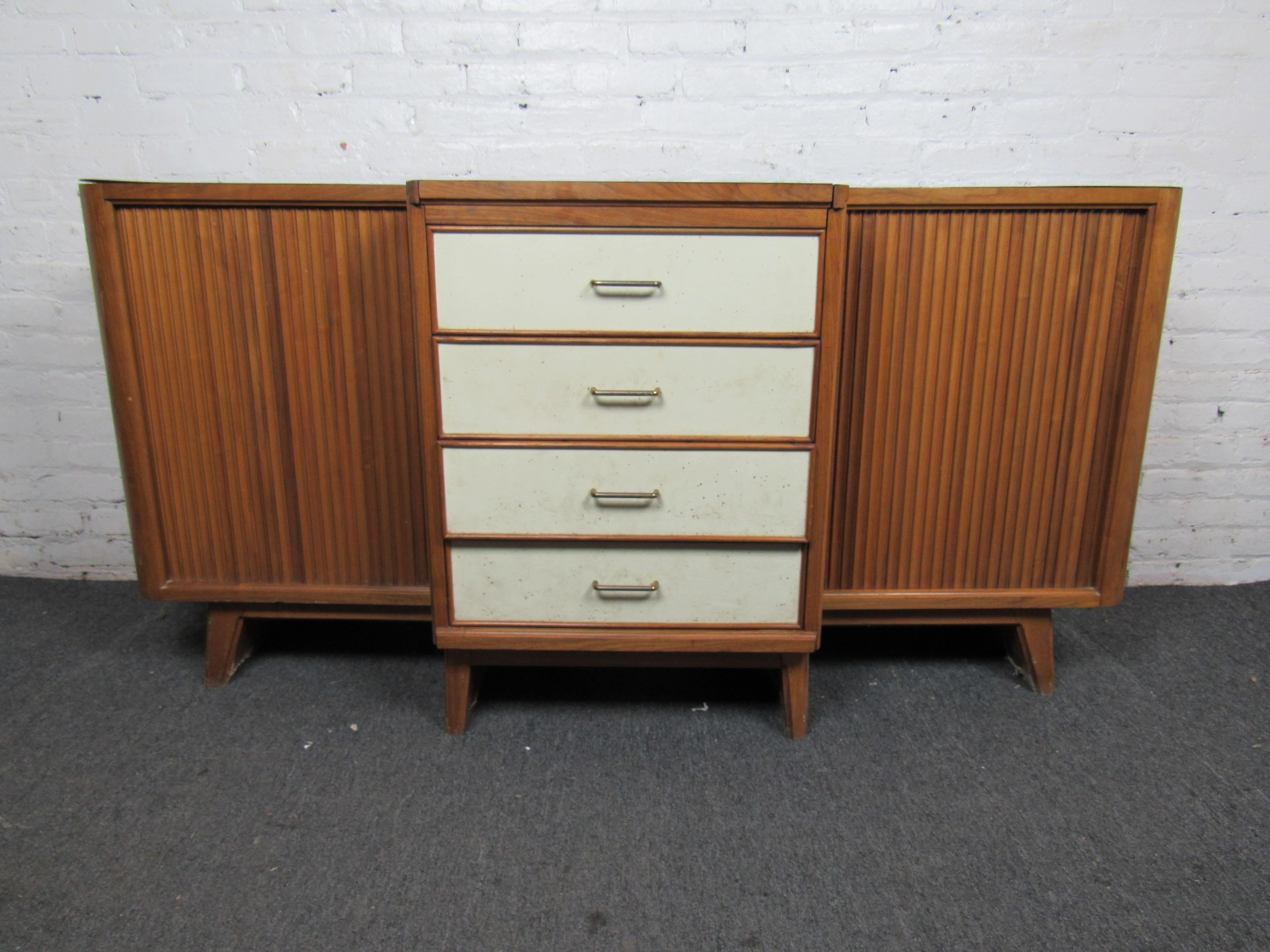 Unique mid-century sideboard with hotplate. Top of sideboard is laminate with the rest made out of solid walnut. Has three drawers with two cabinet spaces on the side for storage. 
(Please confirm item location - NY or NJ - with dealer).
      