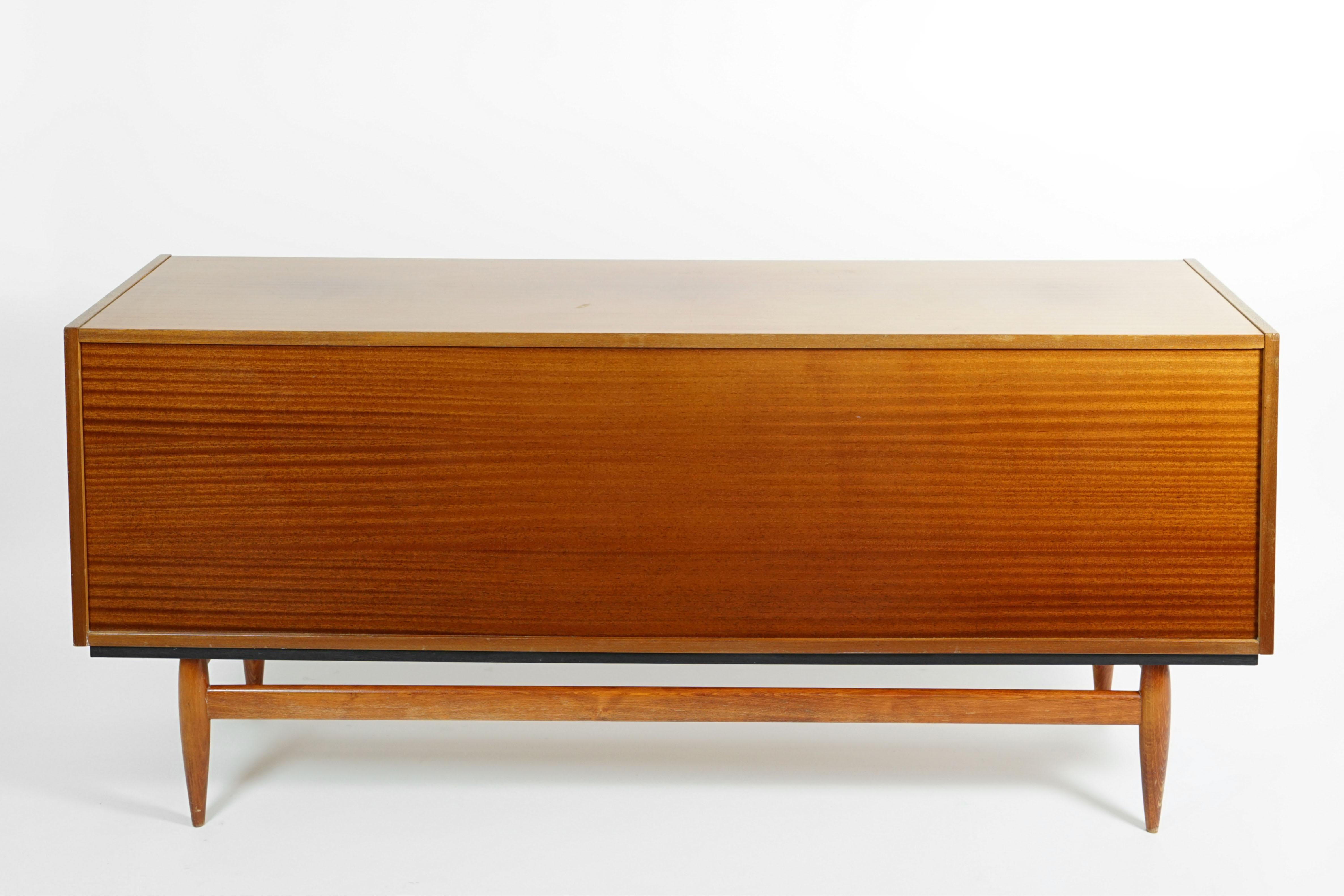 Elegant Sideboard of designer Miroslav Navratil for ULUV, 1960s in former Czechoslovakia.

This rare vintage piece is made of mahogany with a shiny lacquer finish and round brass colored handles.