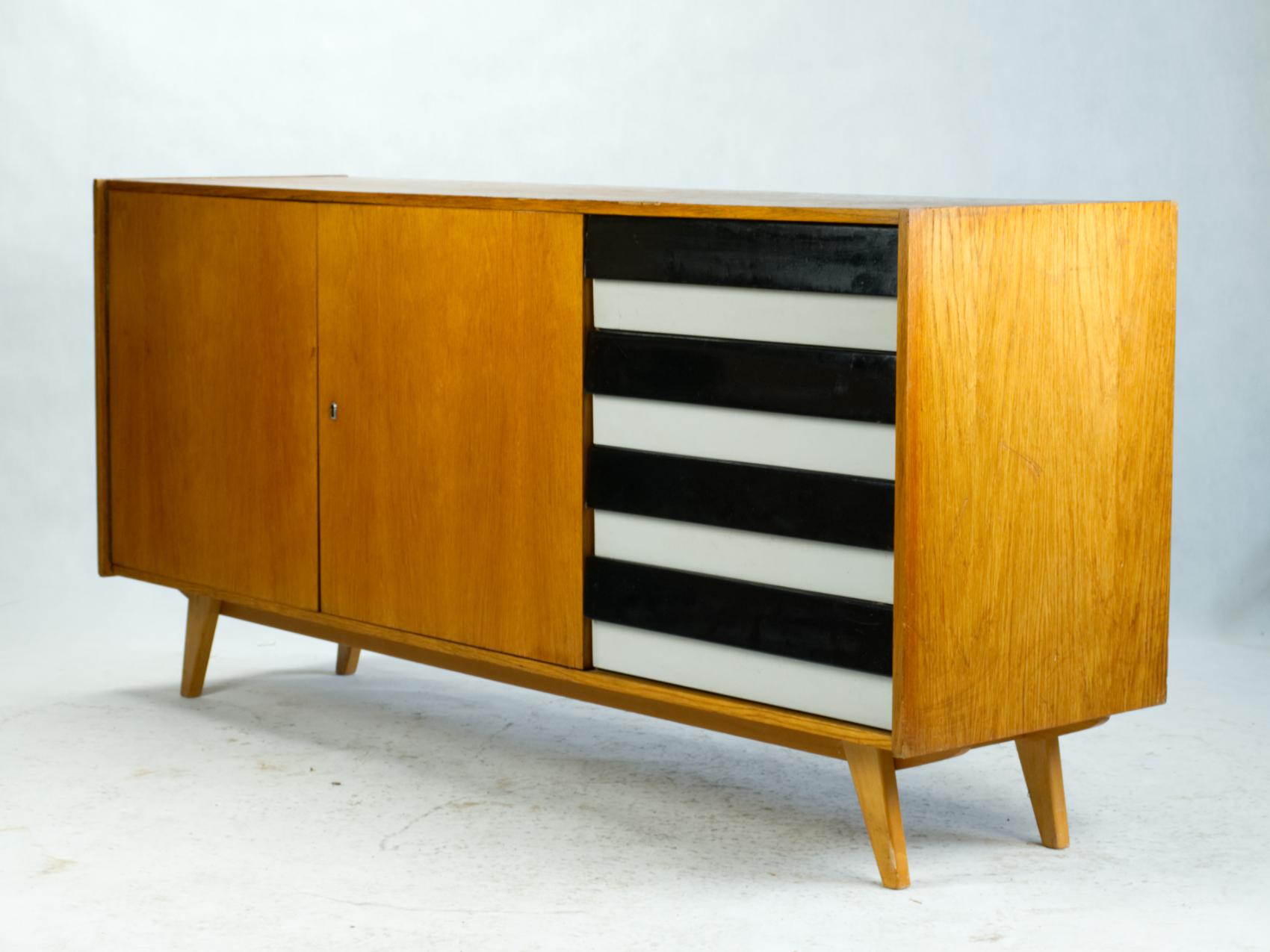 A wide cabinet designed by the Czech designer Jirí Jiroutek as a part of the famous series U-450 for the national enterprise Interier Praha. He began to work on U-450 series right after the ´58 Expo exhibition in Brussels. The success of the Czech