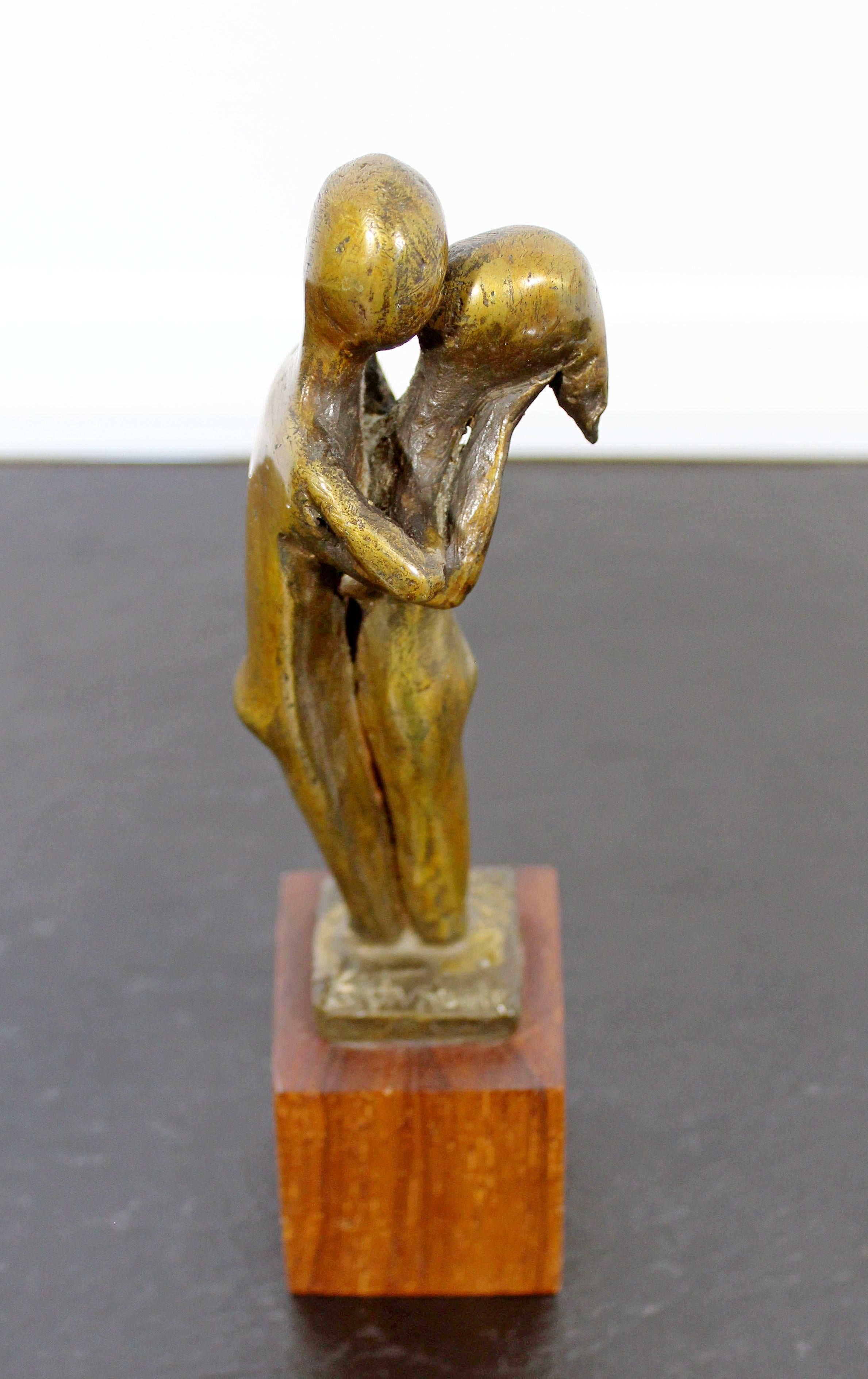 For your consideration is a sweet art sculpture of a couple kissing, made of bronze on a wood base, signed by Arthur Schneider, circa 1970s. In excellent condition. The dimensions are 2