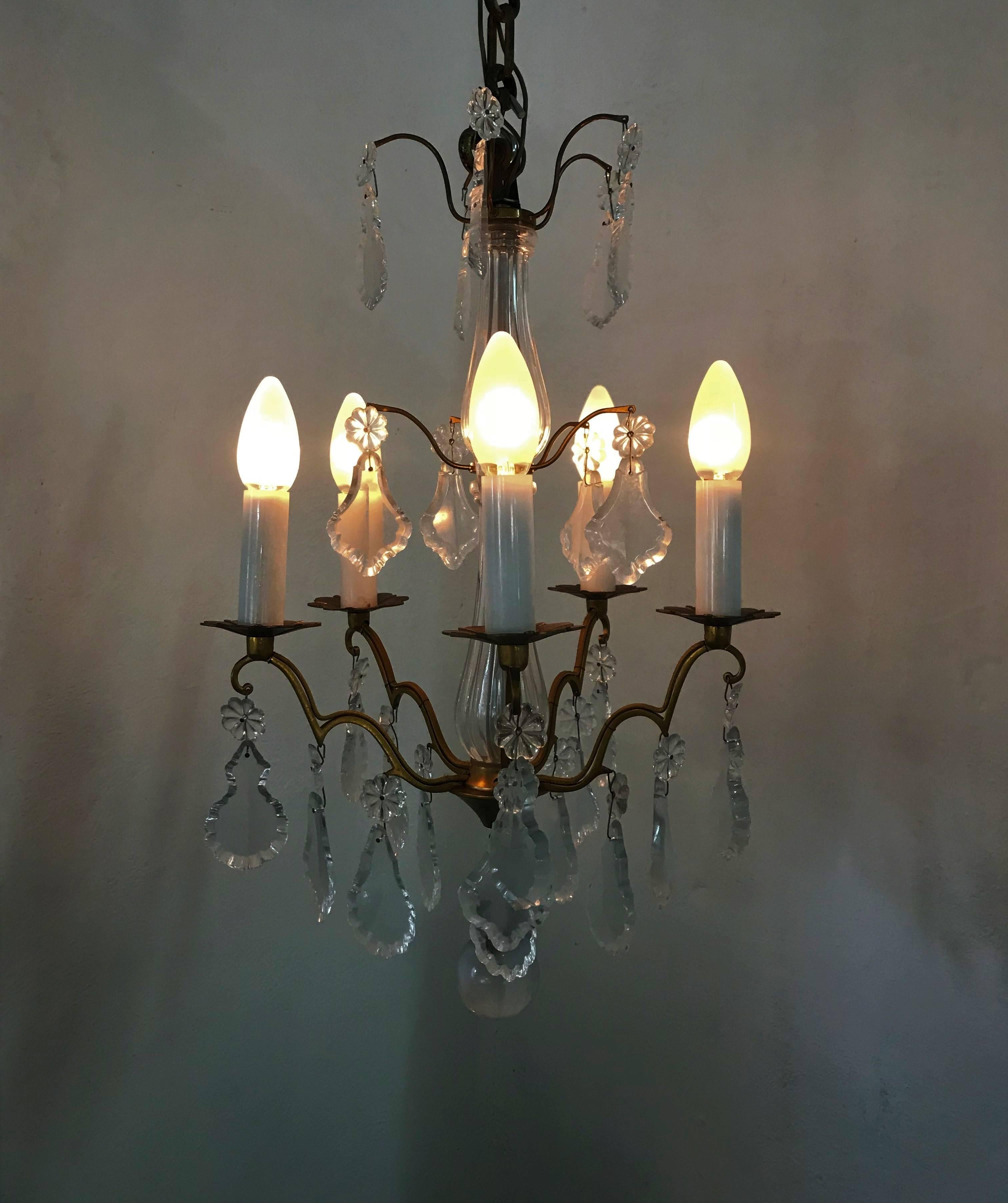 Mid-Century Modern five-light bronze and cut lead crystal chandelier by Baccarat, France, circa 1950. Stamped with the Baccarat mark on the bronze.
 