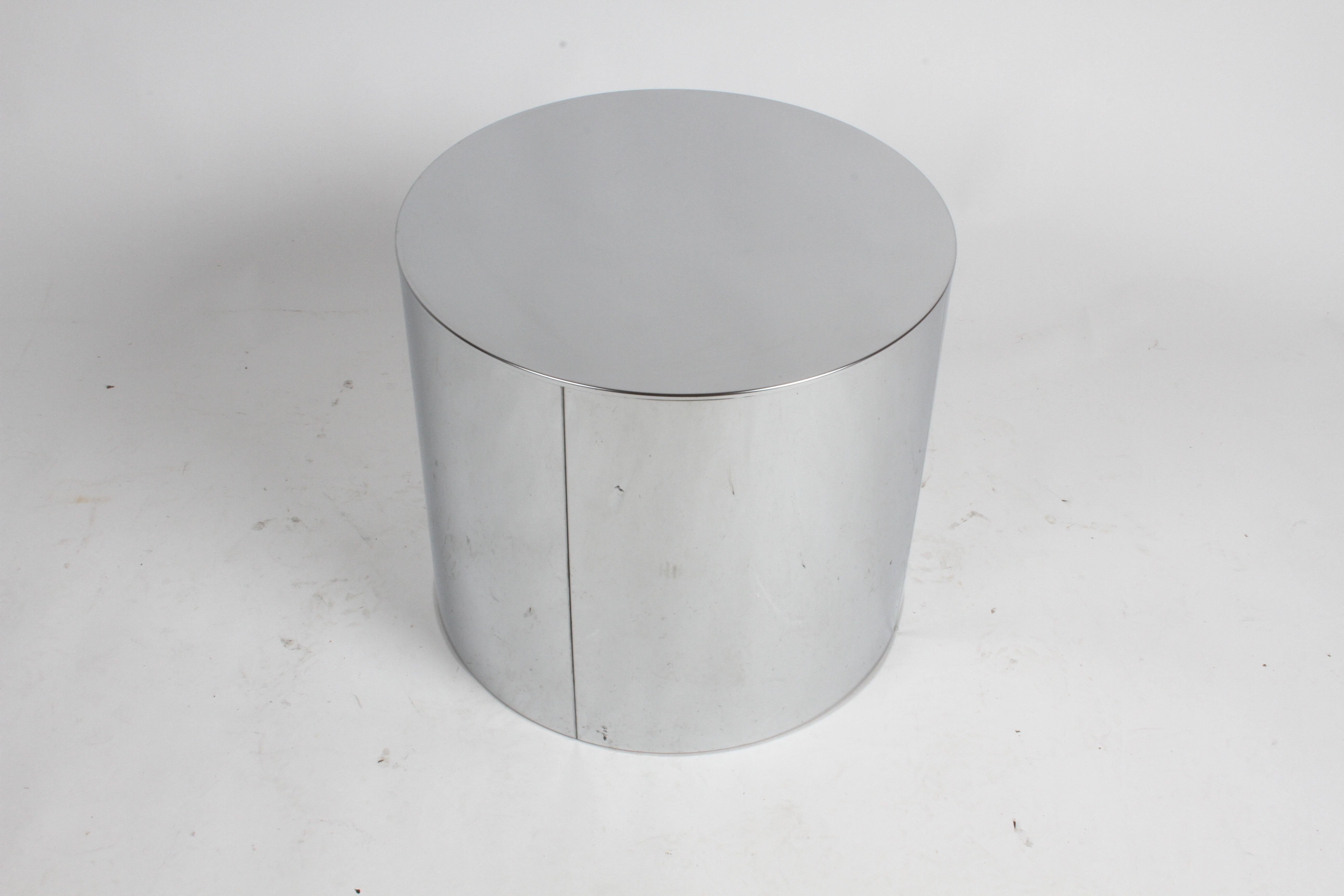 Hollywood Regency Curtis Jeré Chrome drum form end, side table or display pedestal. Signed C. Jere, circa 1970s. Wear to finish on tops, some patina on sides, minor dings, metal is reflective, so it picked up at lot flaws on the paper and projected