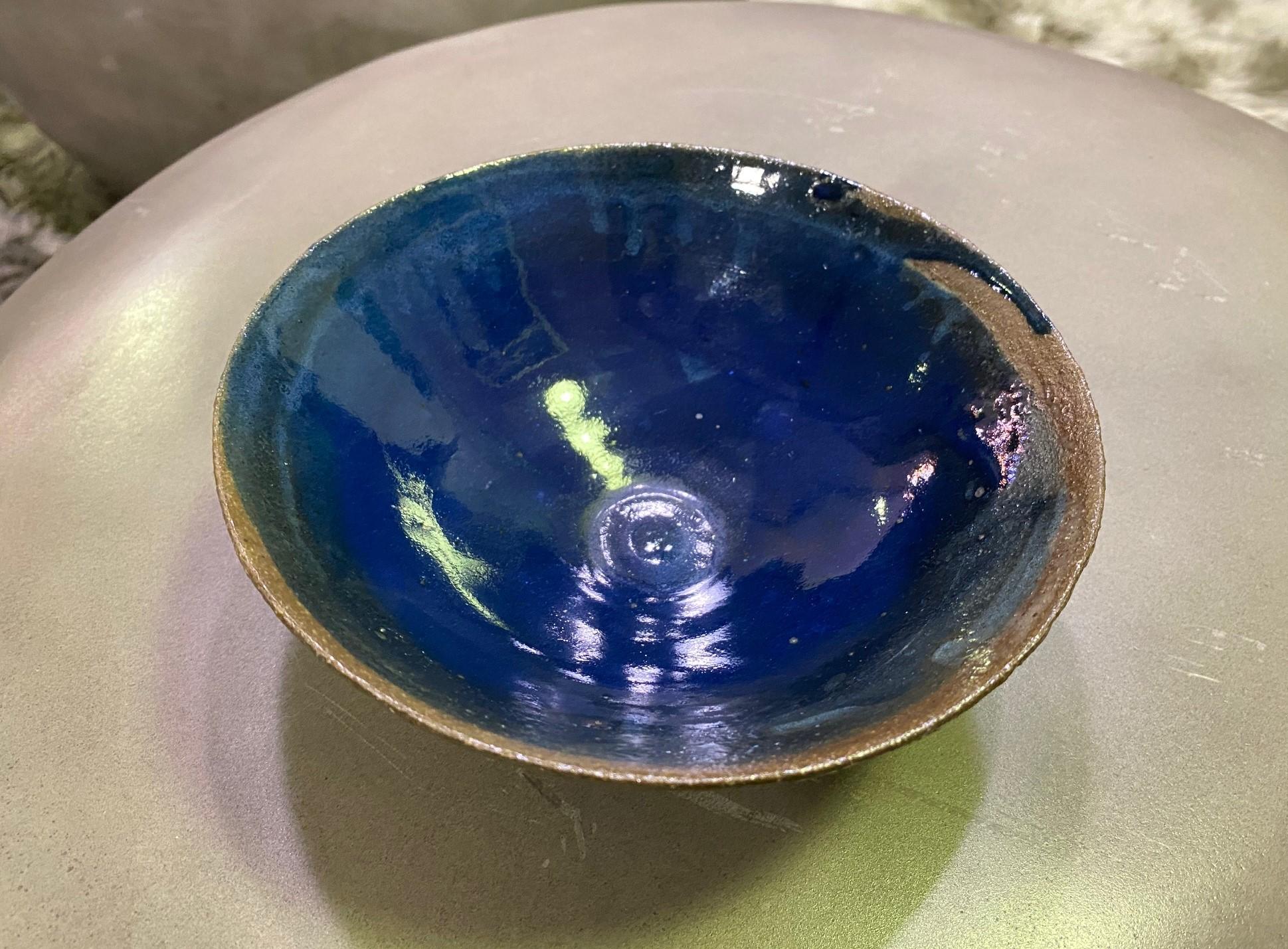 Wonderful work. The deep, rich blue glaze is spectacular. Very well done by an artist at the top of his or her craft.

Signed on the base.

We can't place the maker. It did come from a collection of very well known midcentury potters and was