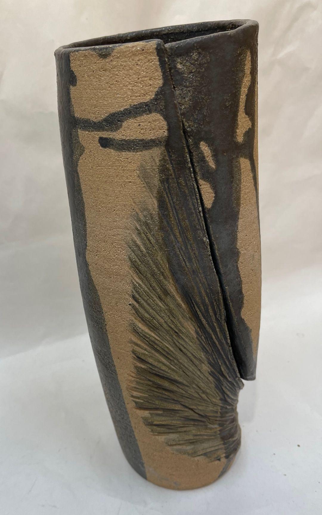 Awesome Modernist tall Studio vase featuring Matte Greenish grey abstract designs. Beautifully Hand-crafted One of a Kind Vase by a master potter. Measures: Approx. 11.5” H x 3.75” D. Signed: Harry V on underside. Beautiful addition to your home,